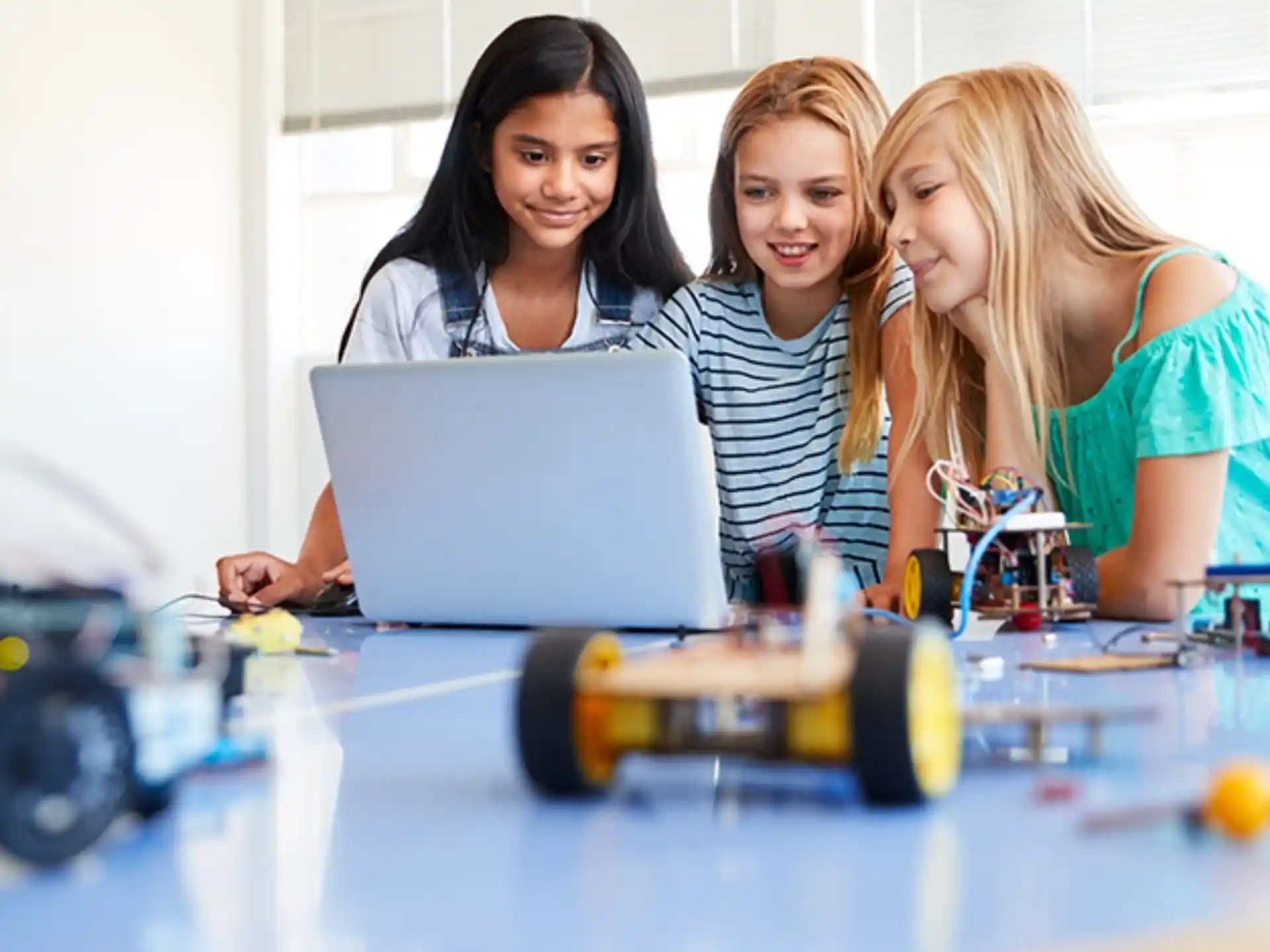 a few young women working on a laptop