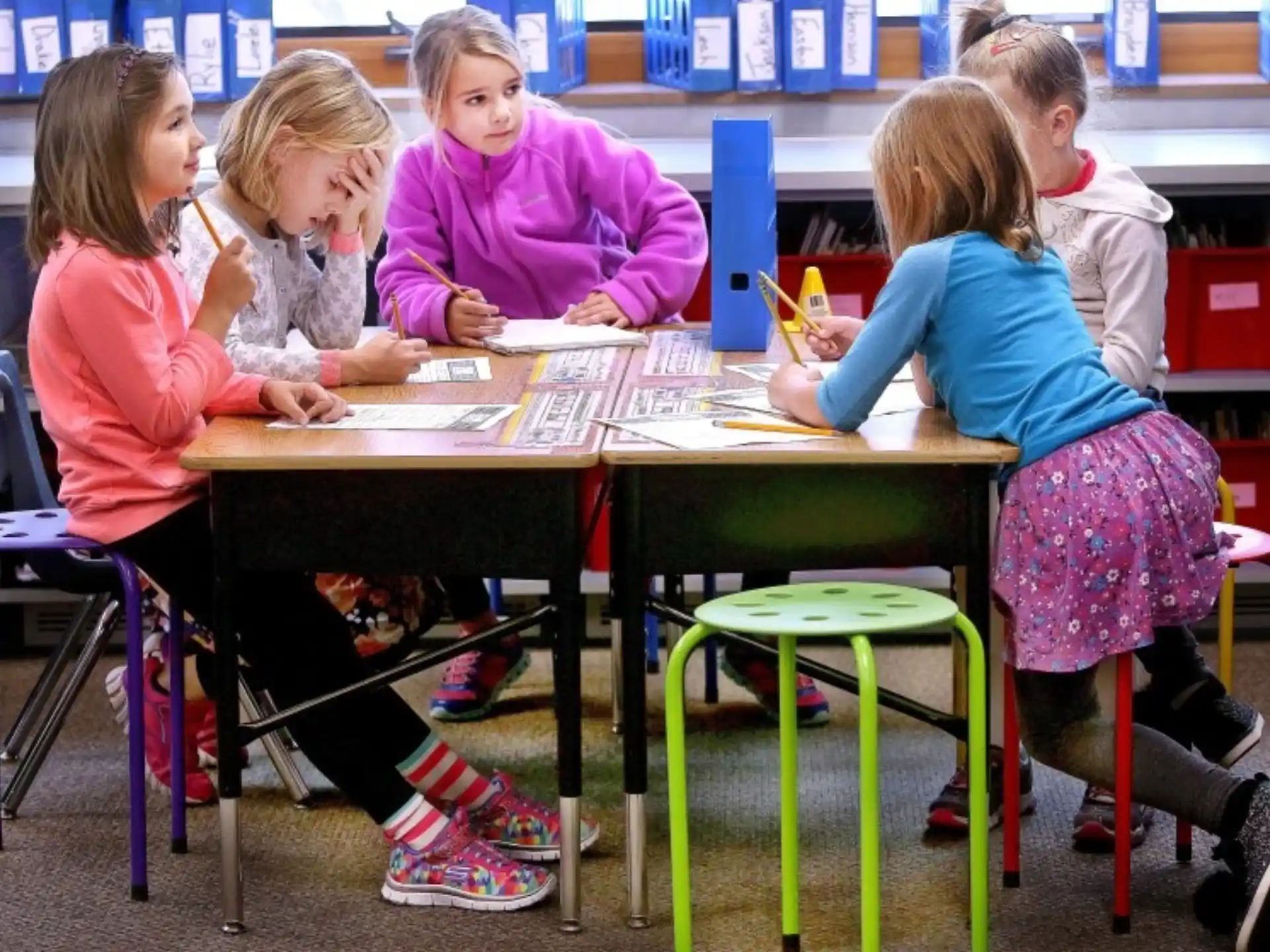 a group of children sitting at a table