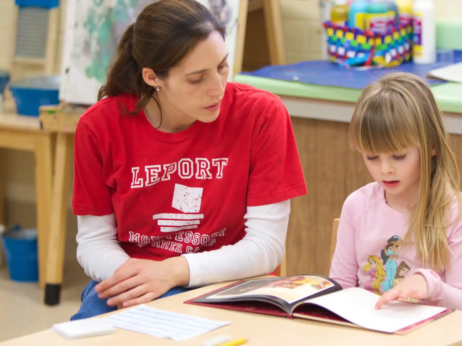 a person and a child reading a book