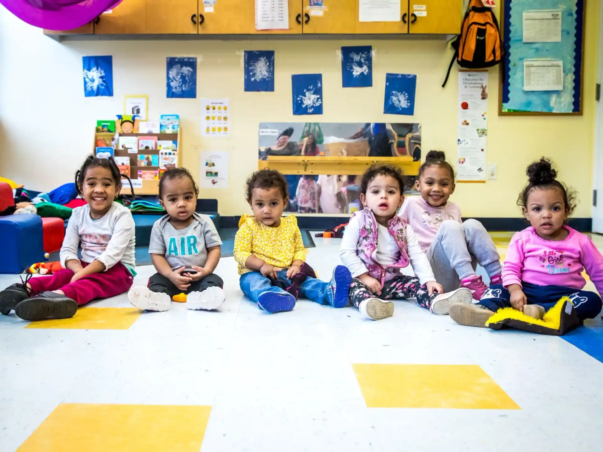 a group of children sitting on the floor
