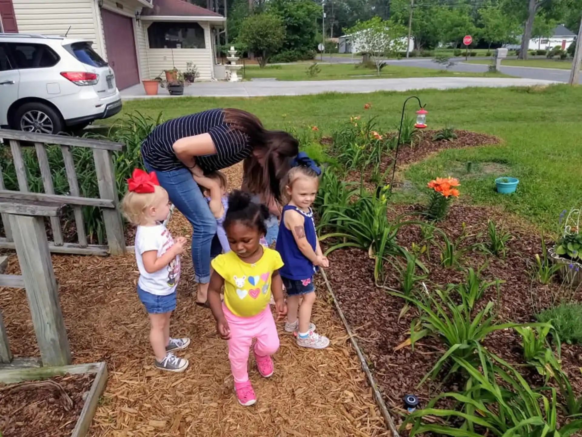 a person and several children in a garden