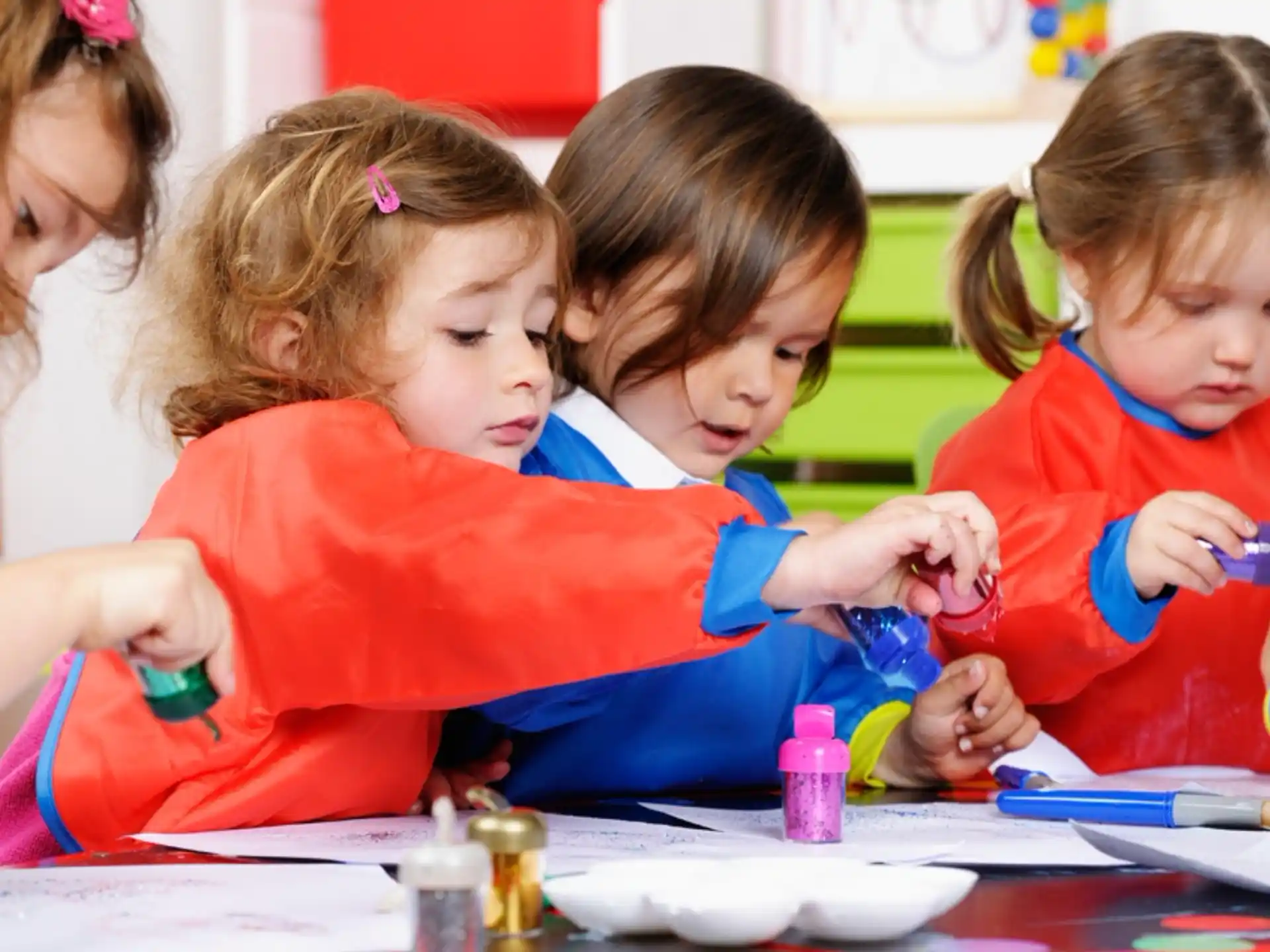 a group of children sitting at a table