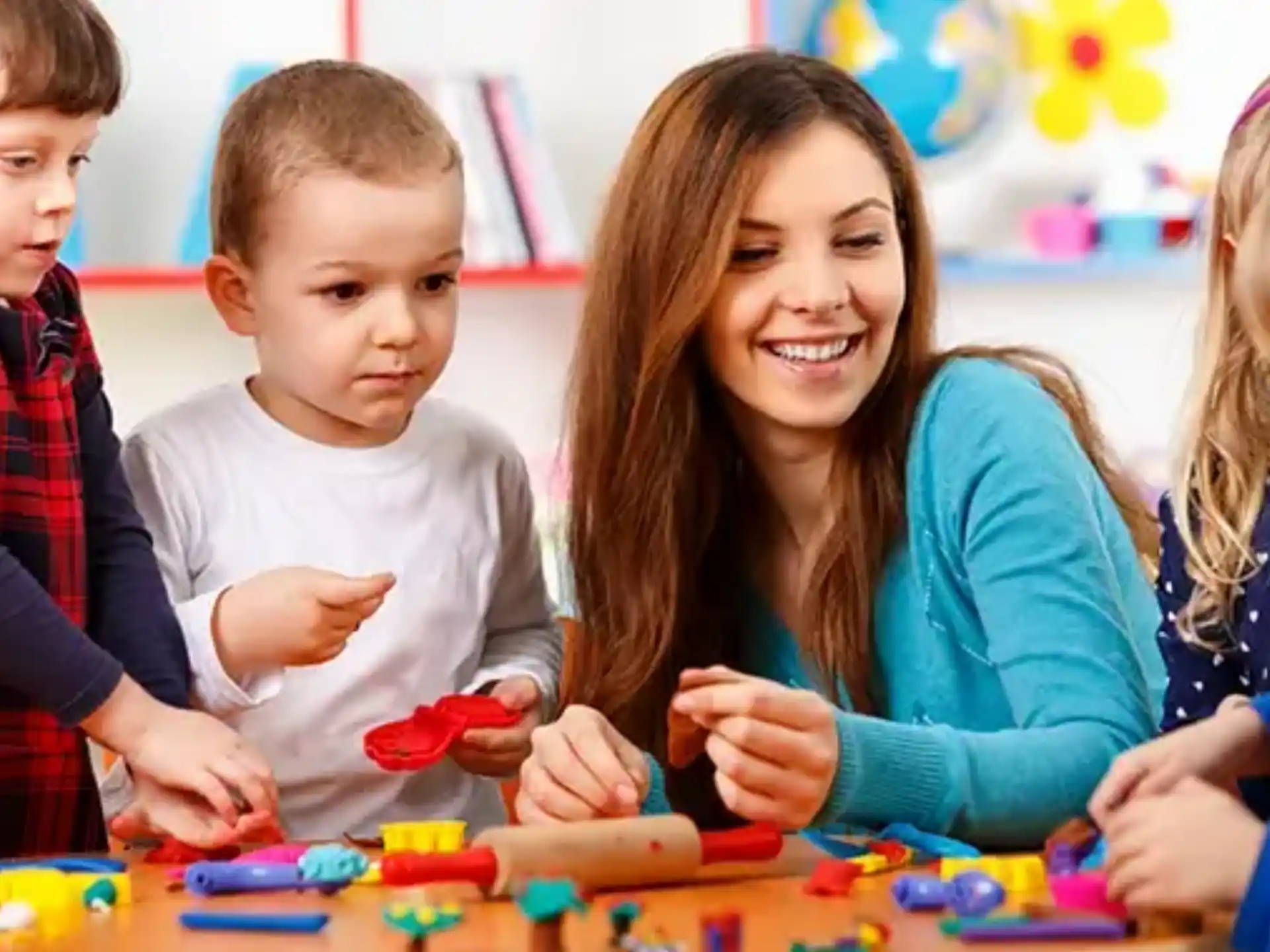 a person and several children playing with toys