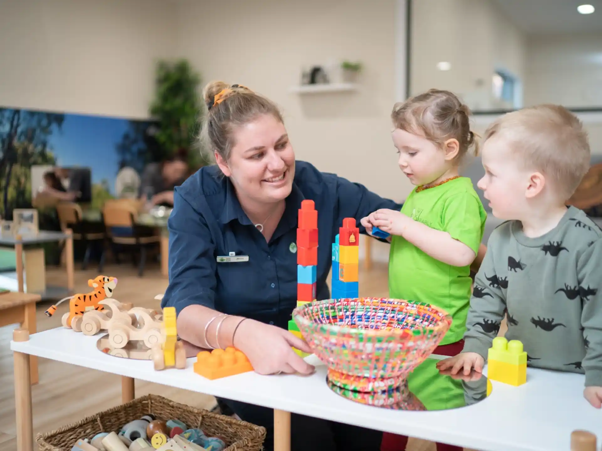 a person and two children with a cake