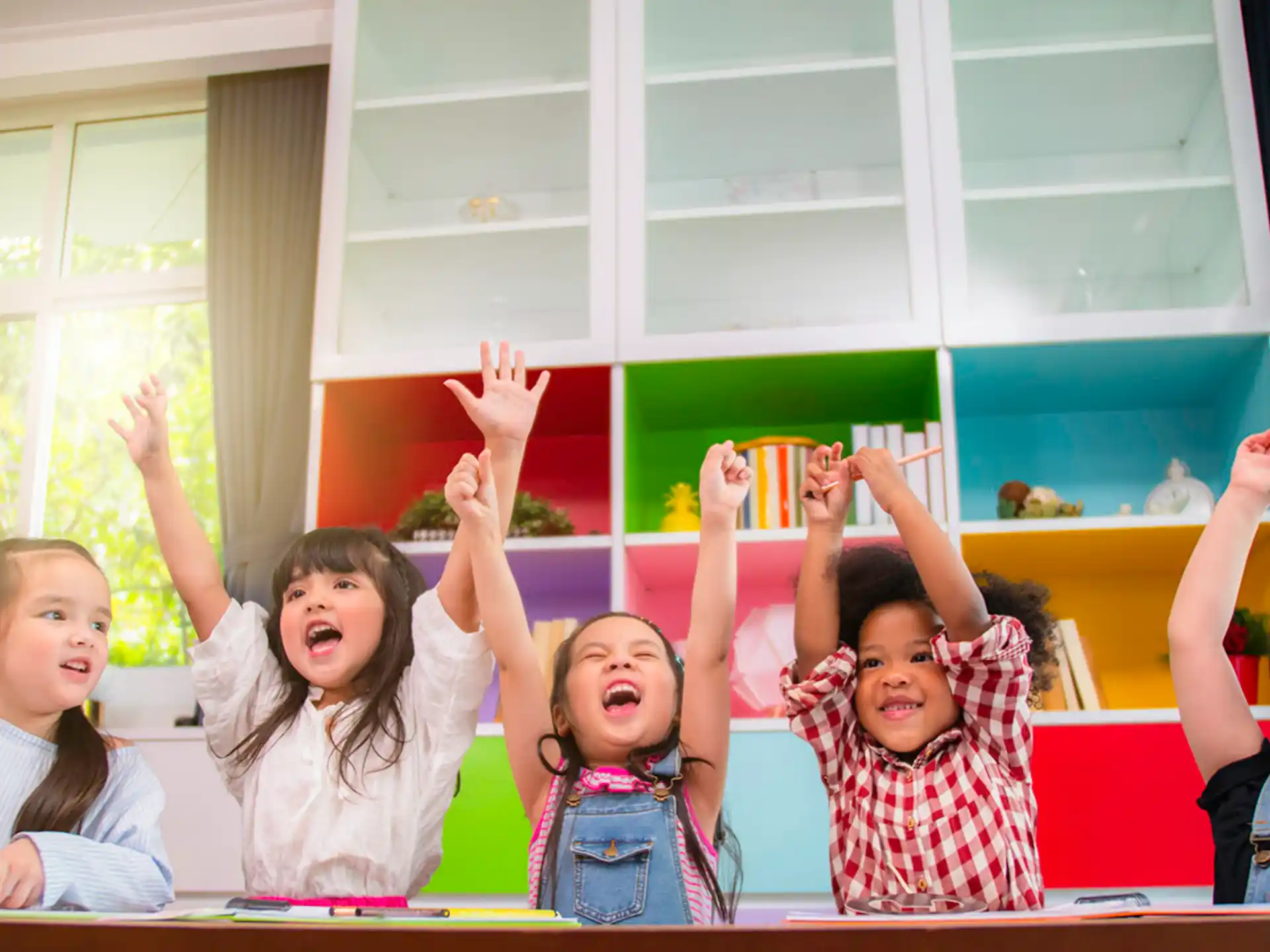 a group of children raising their hands