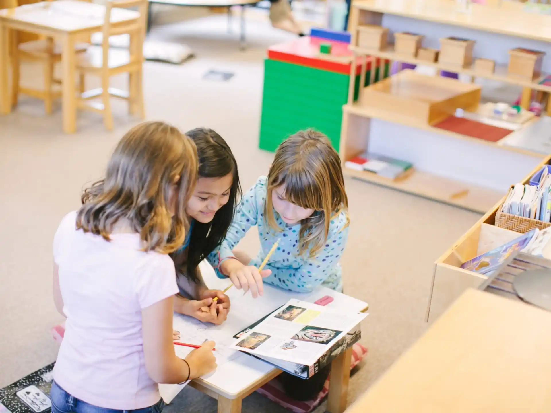 a few young girls studying in a library
