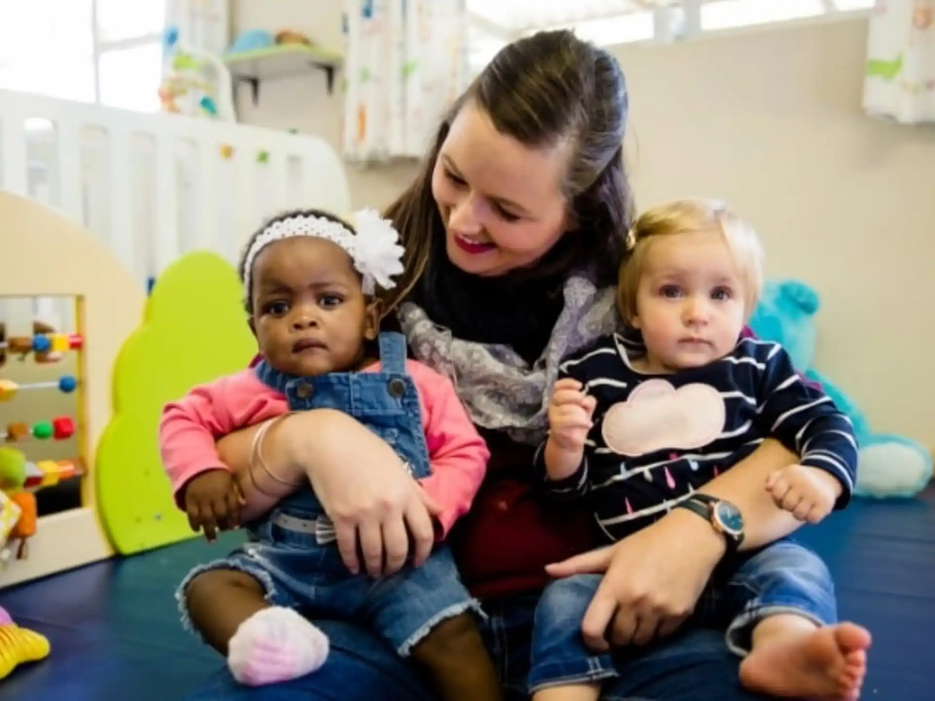 a person holding two children