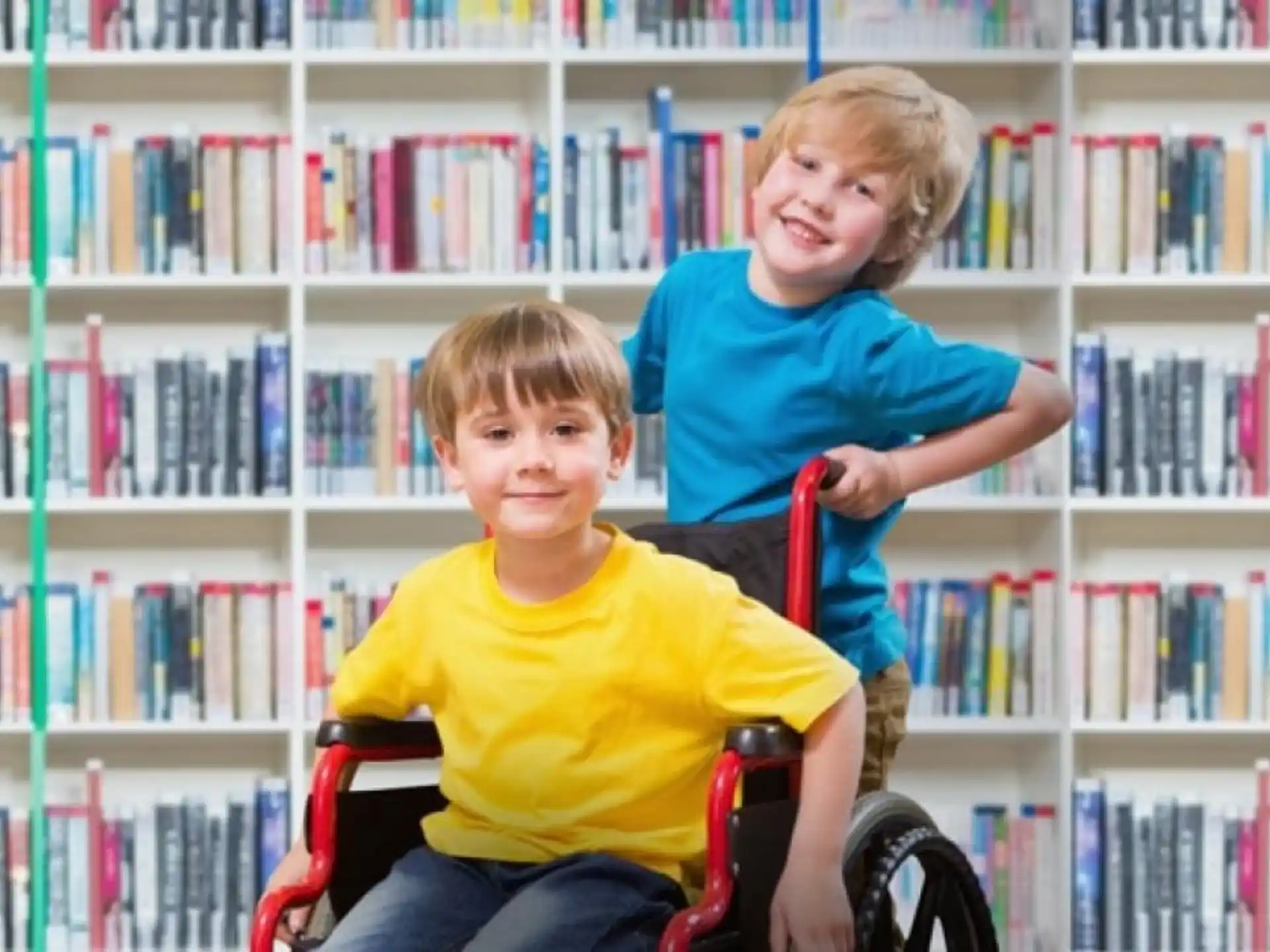 a couple of boys sitting in a library