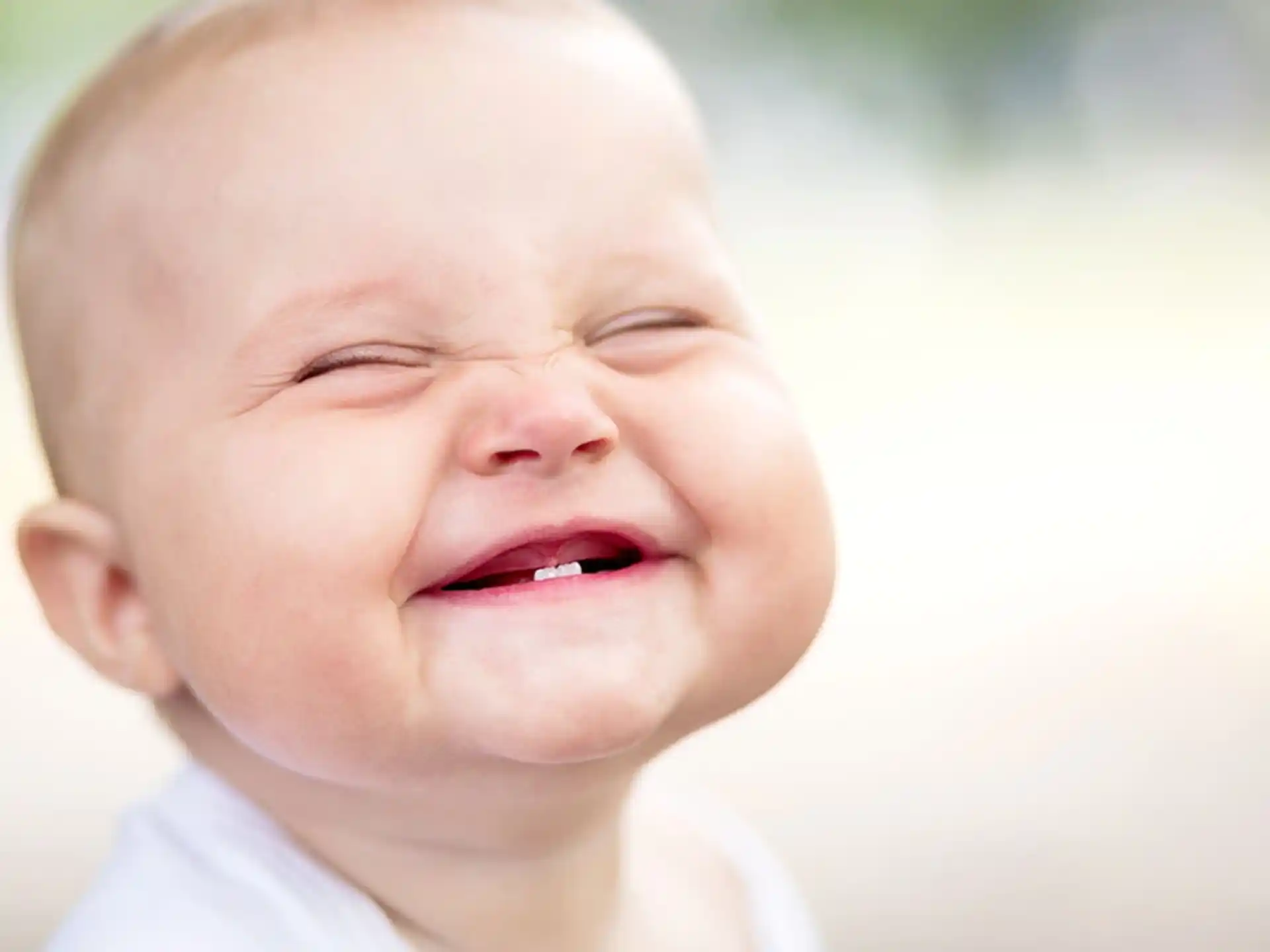a baby crying with its eyes closed