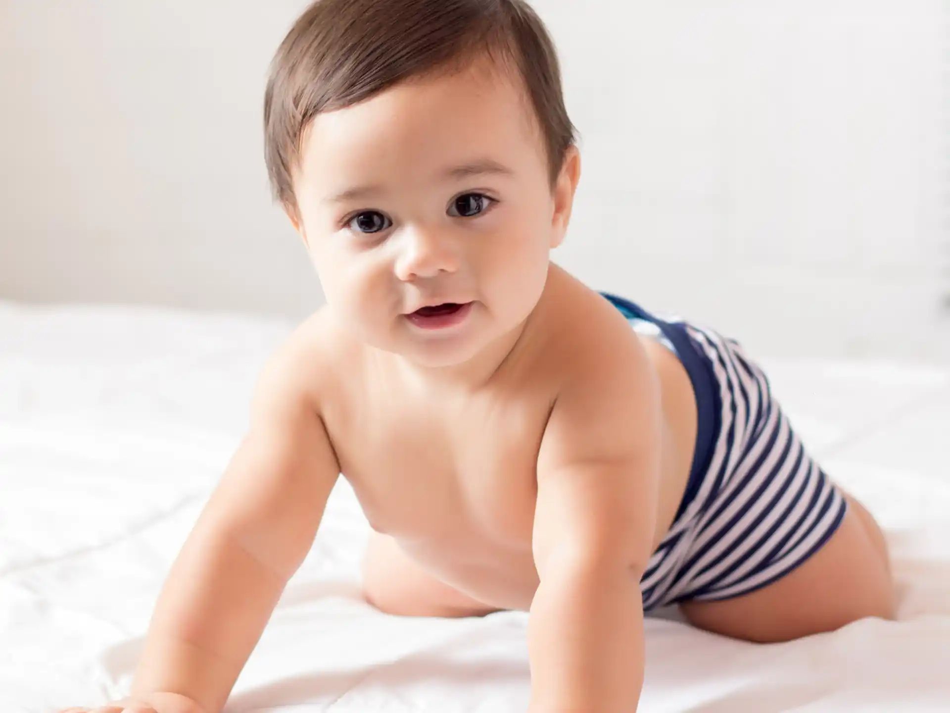 a baby lying on a bed