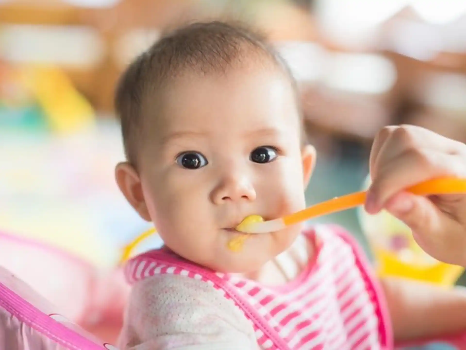 a baby with a toothbrush in its mouth