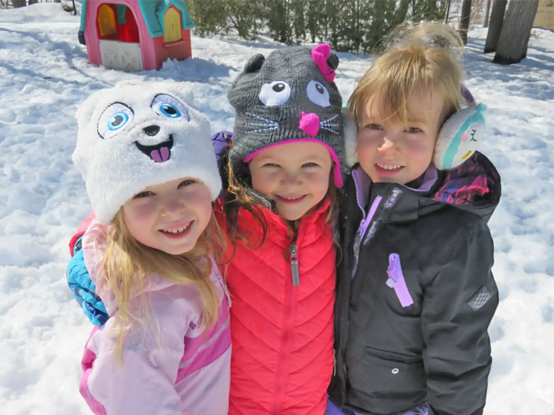 a group of children posing for a photo in the snow