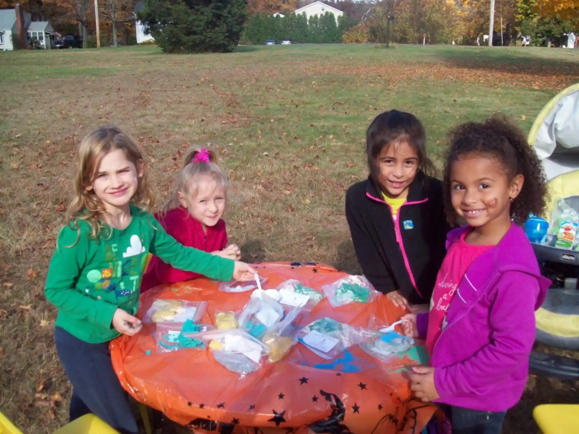 a group of girls holding a large colorful box