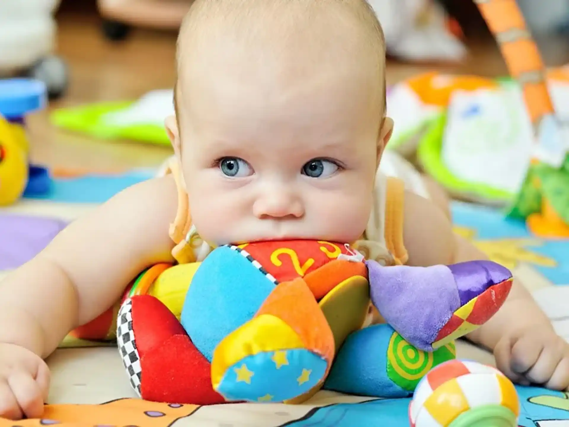 a baby lying on a blanket