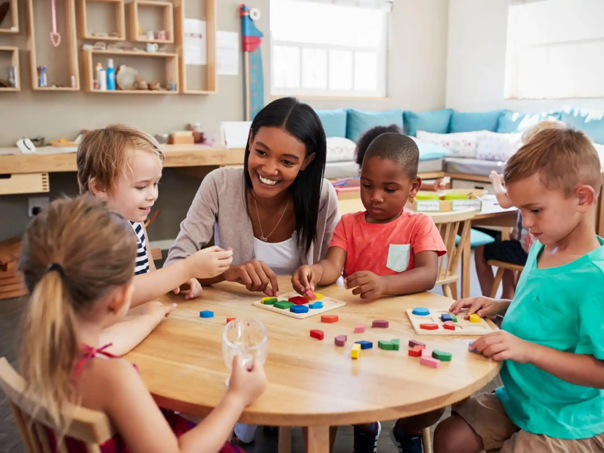 a person and several children sitting at a table