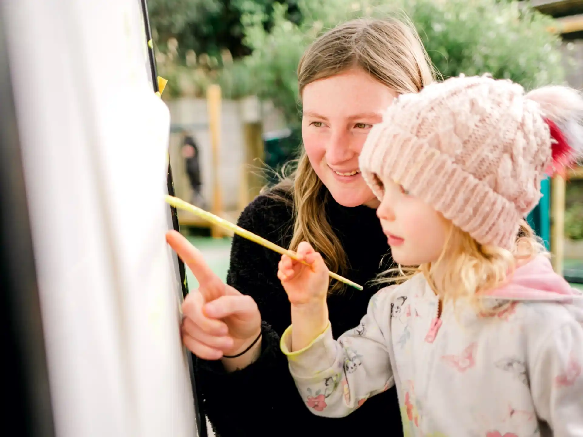 a person and a child painting