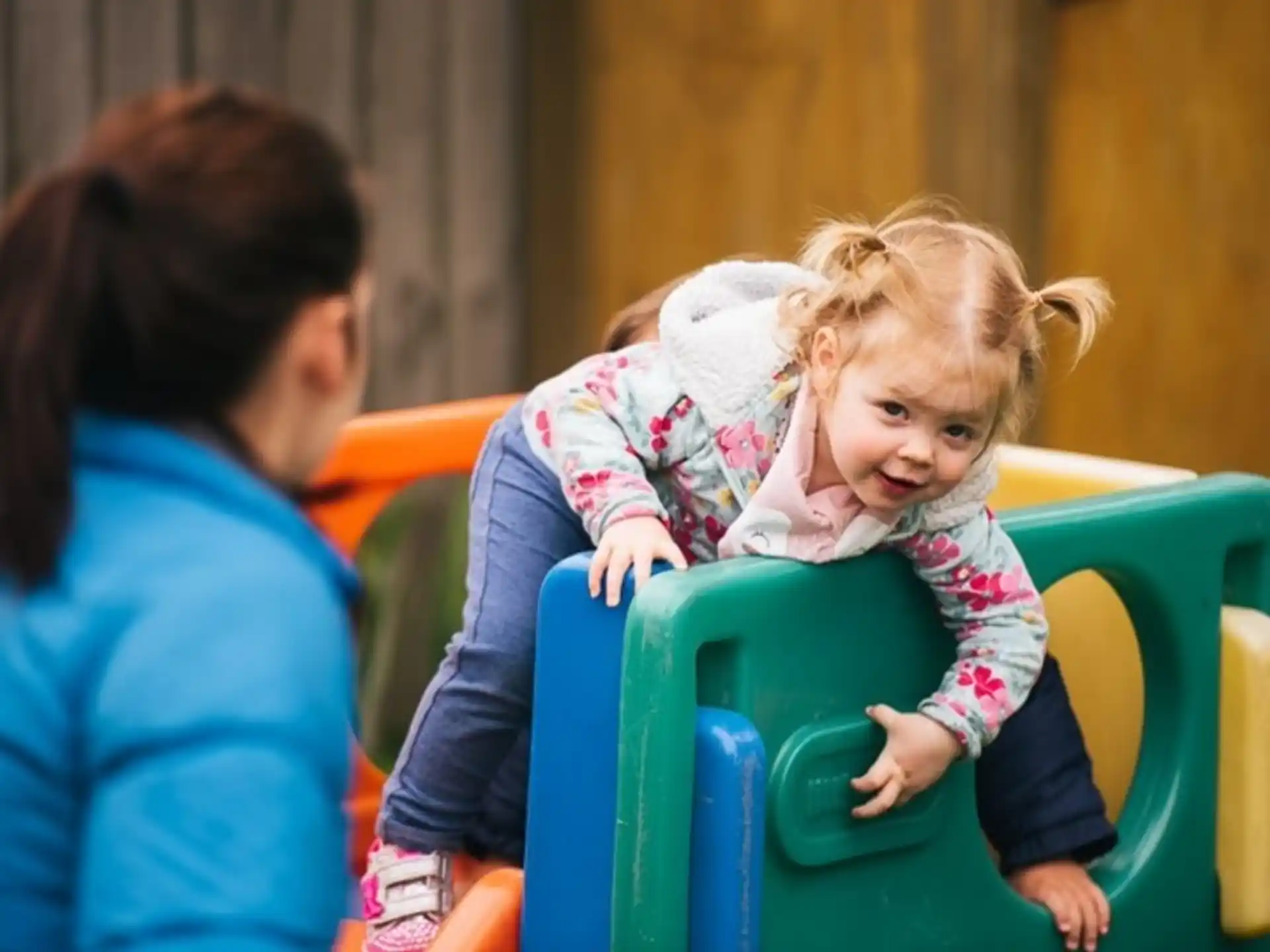 a person and a child sitting in a chair