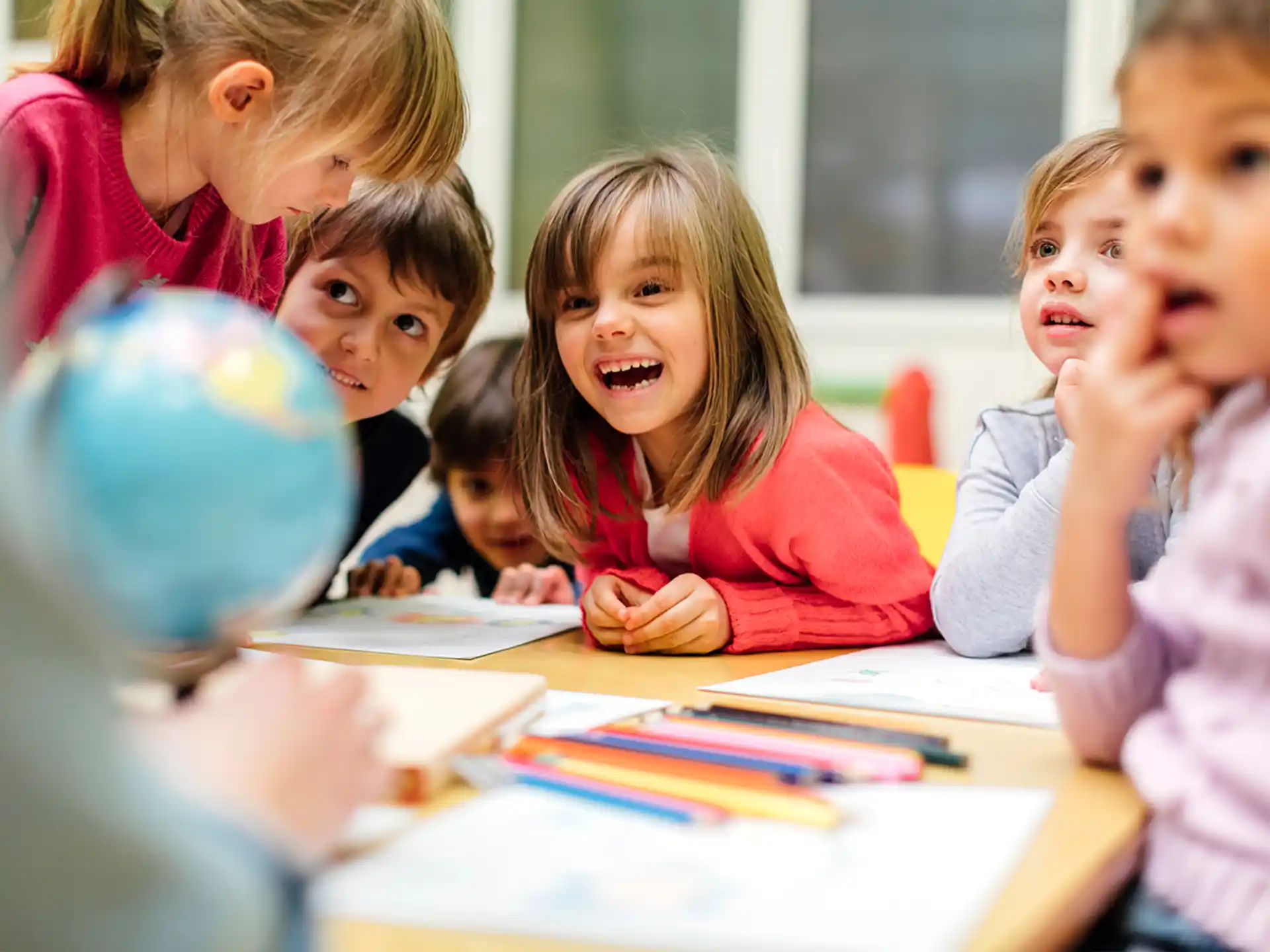a group of children sitting at a table