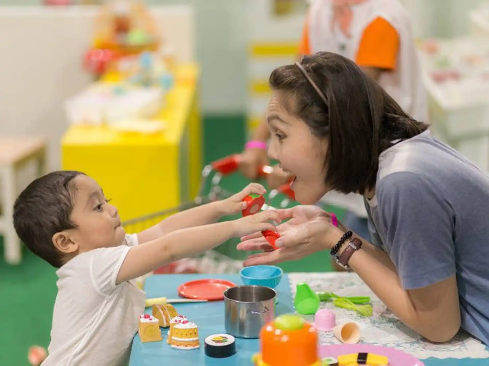 a person and a child playing with toys