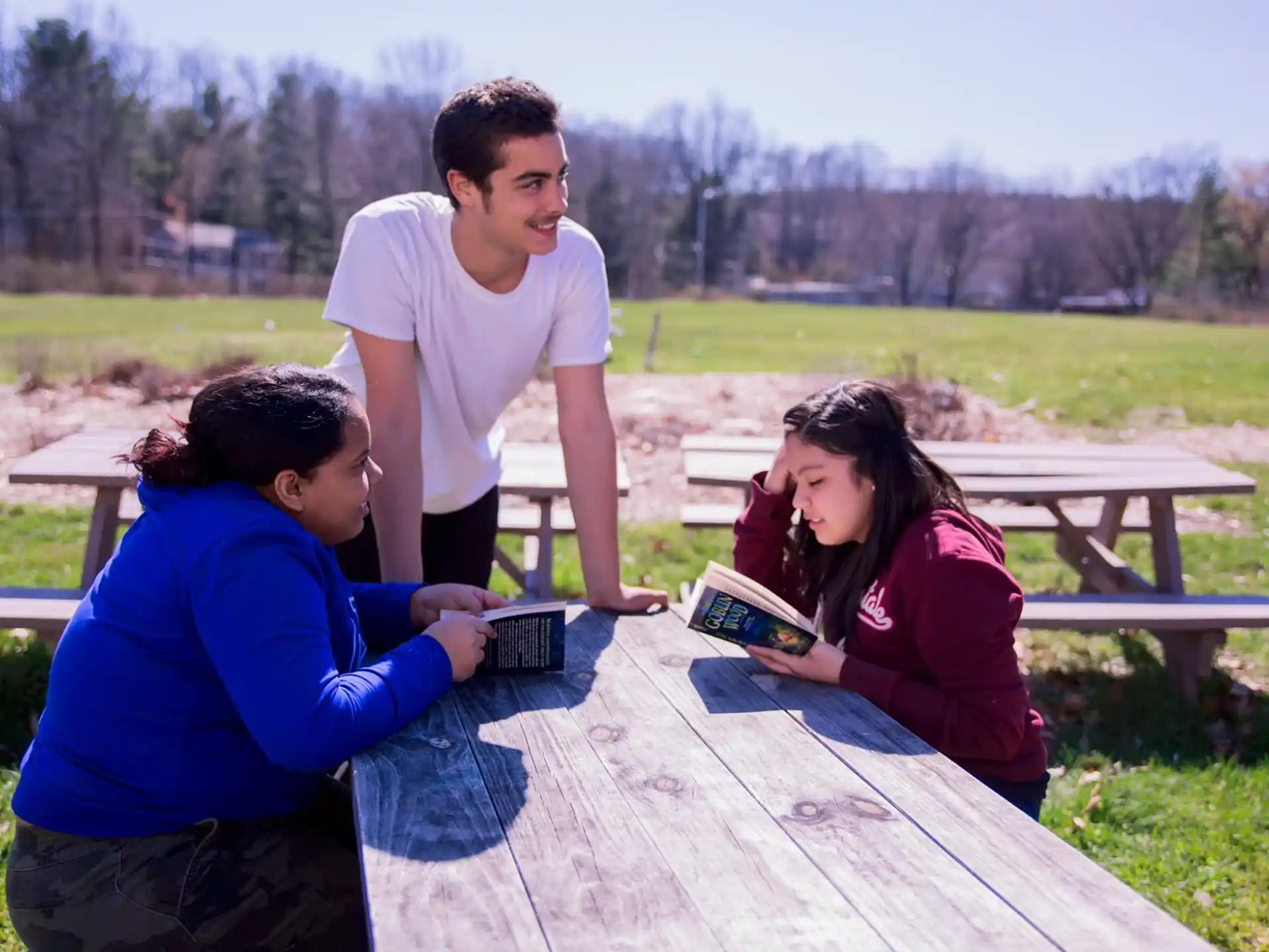 a group of people sitting at a picnic table