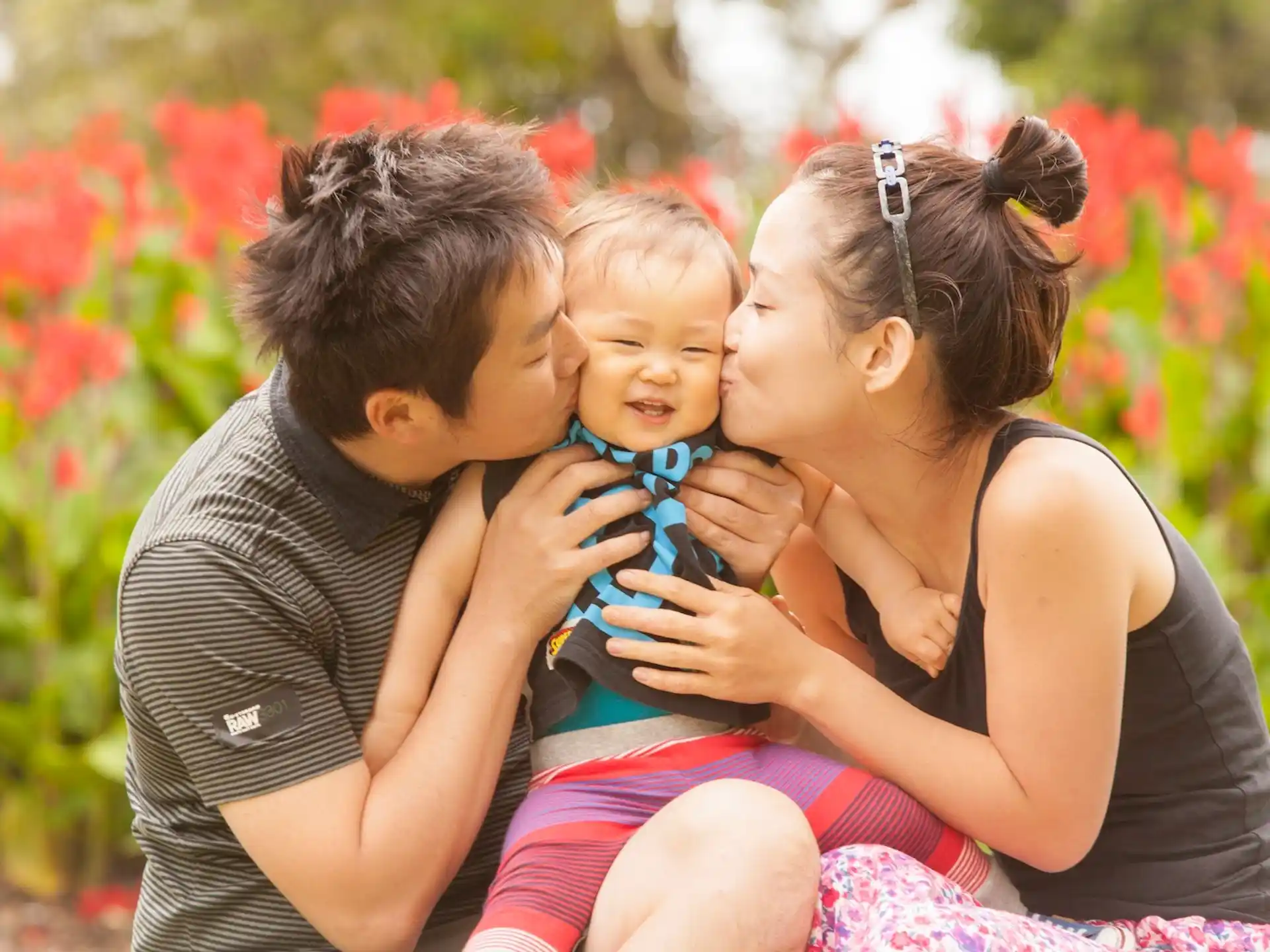 a man and woman holding a baby