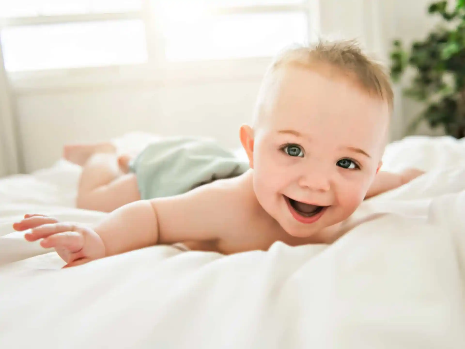 a baby lying on a bed