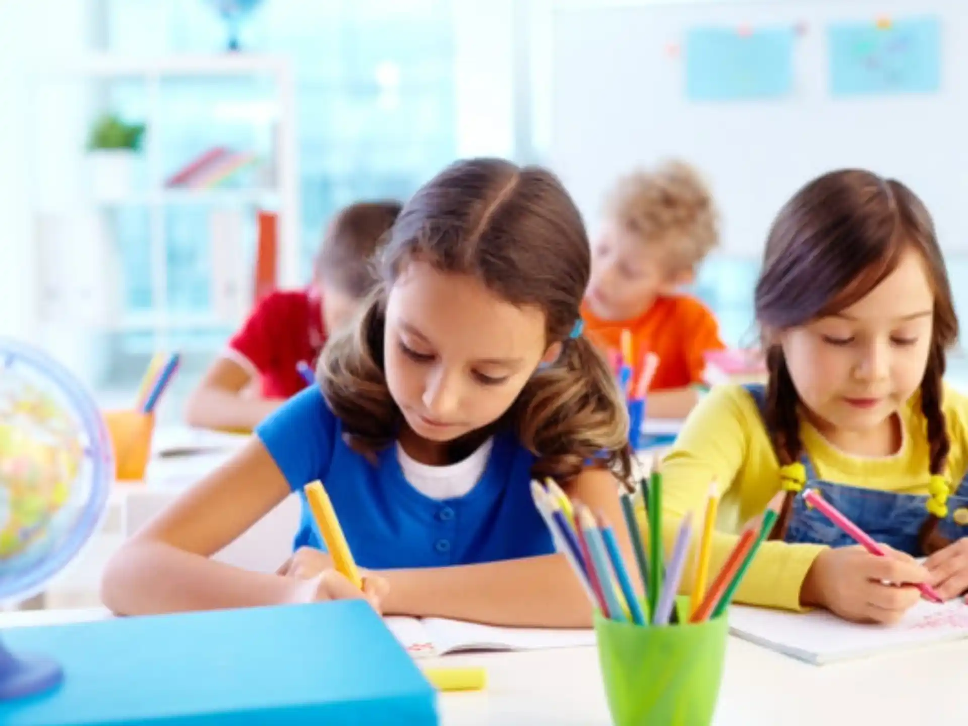 a group of children sitting at a table