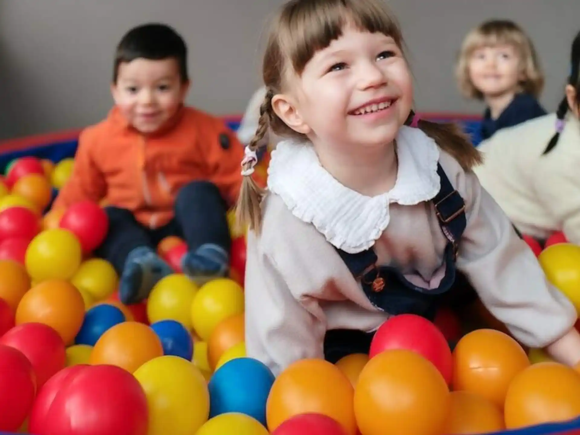 a group of children in a ball pit