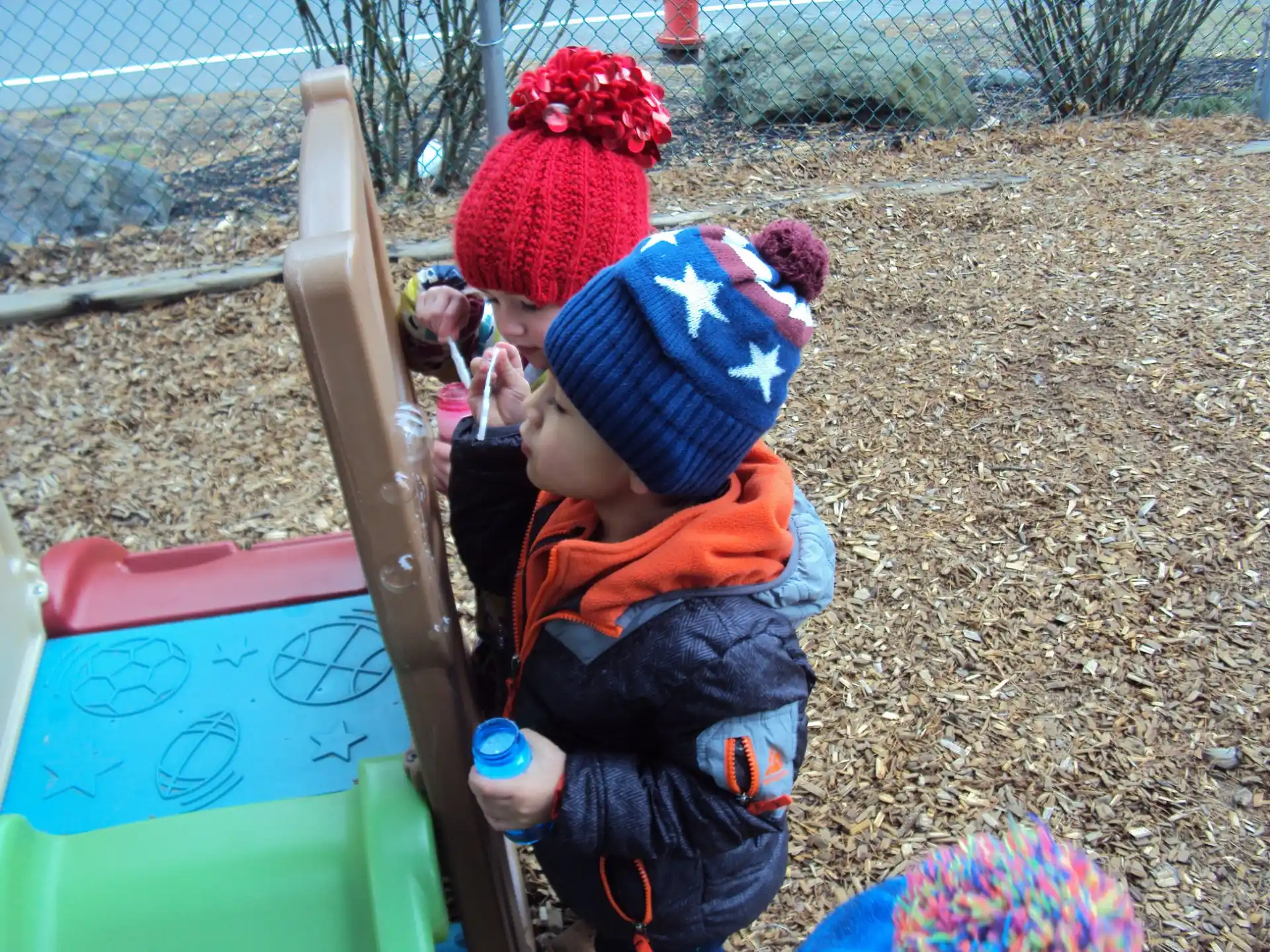 a couple of children playing in a playground