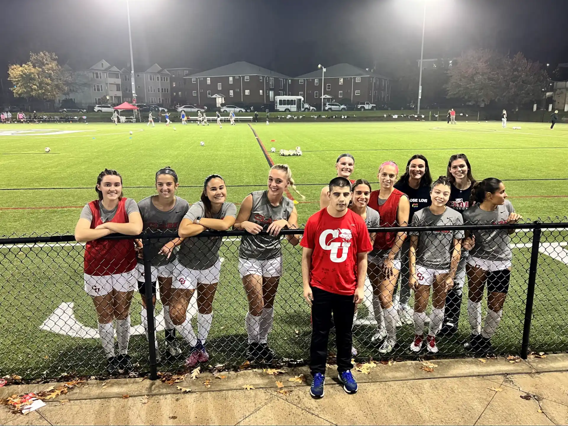 a group of people posing for a photo on a field