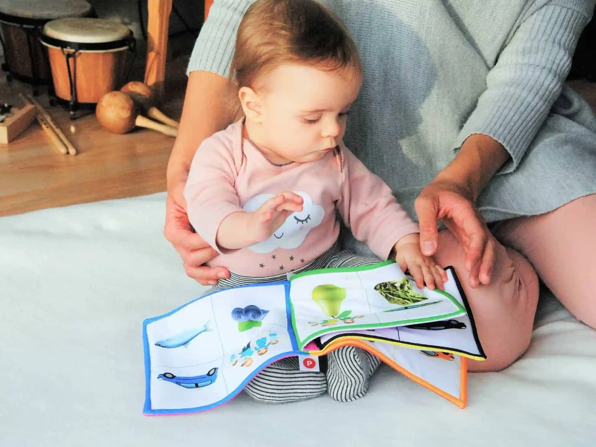 a person and a baby playing with a puzzle