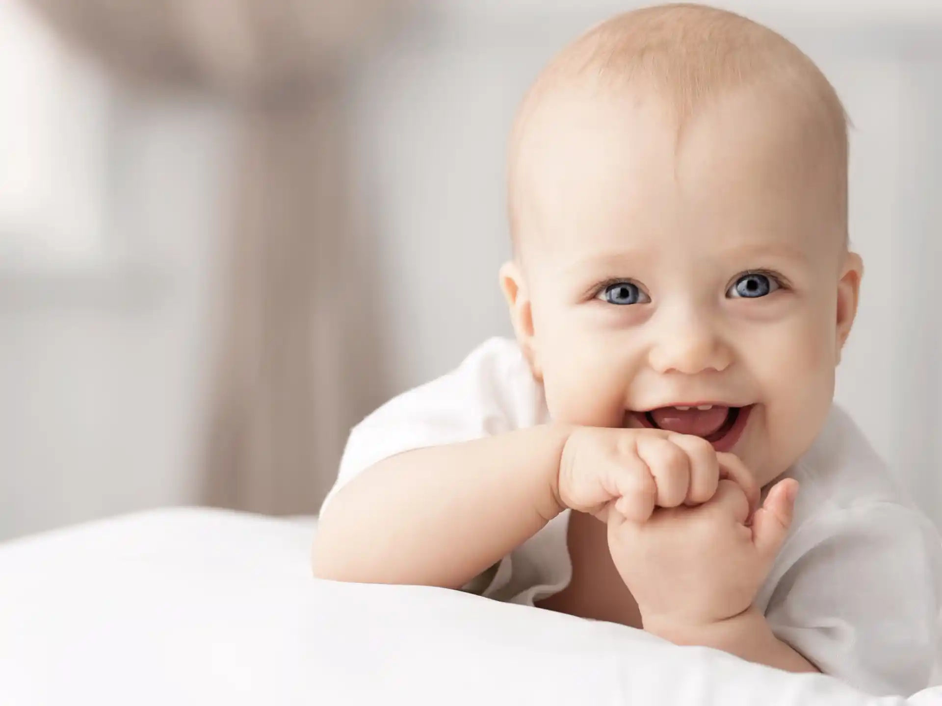 a baby with a hand on its chin