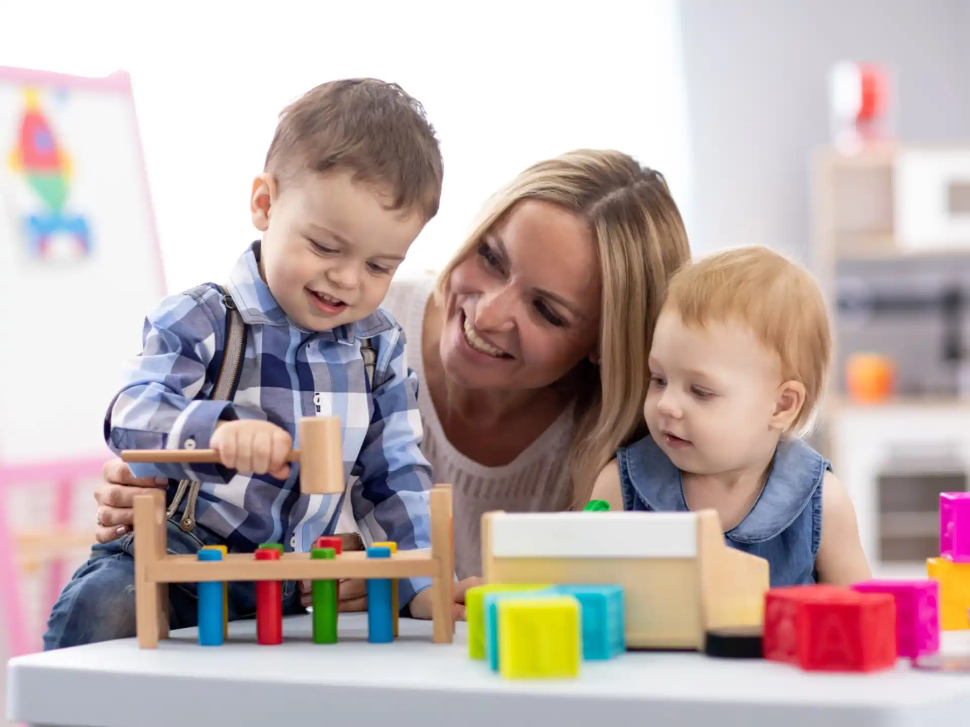 a person and two children playing with toys