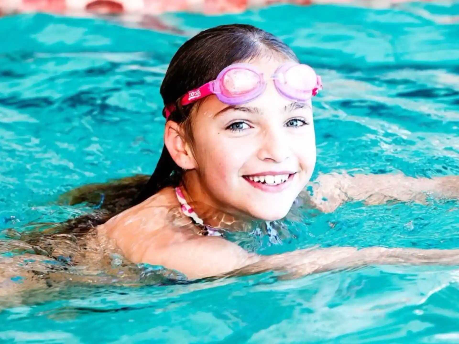 a girl swimming in a pool