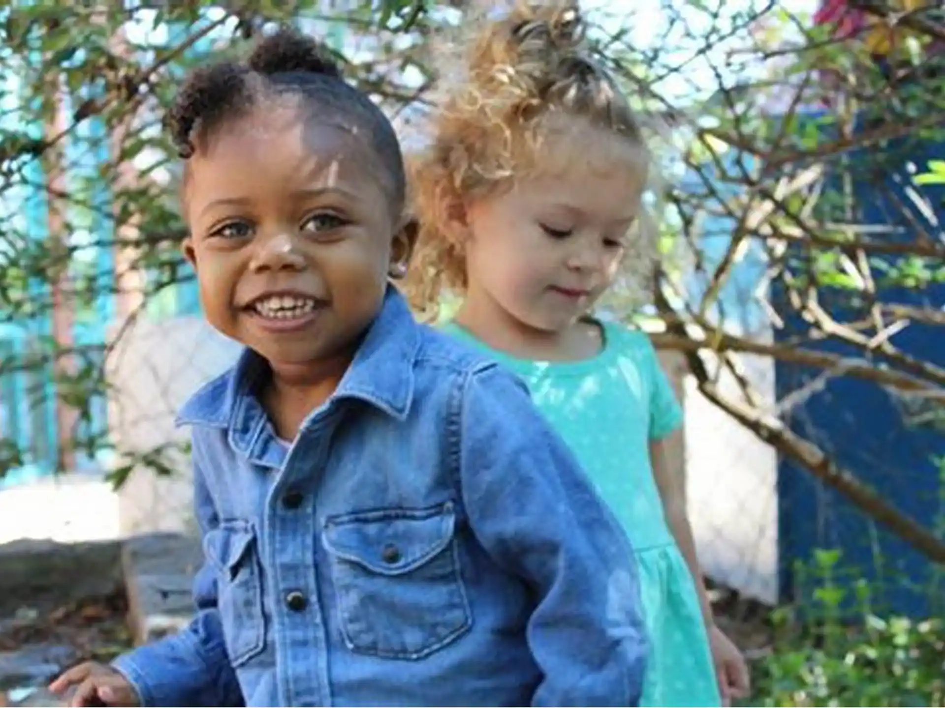 a boy and a girl posing for a picture