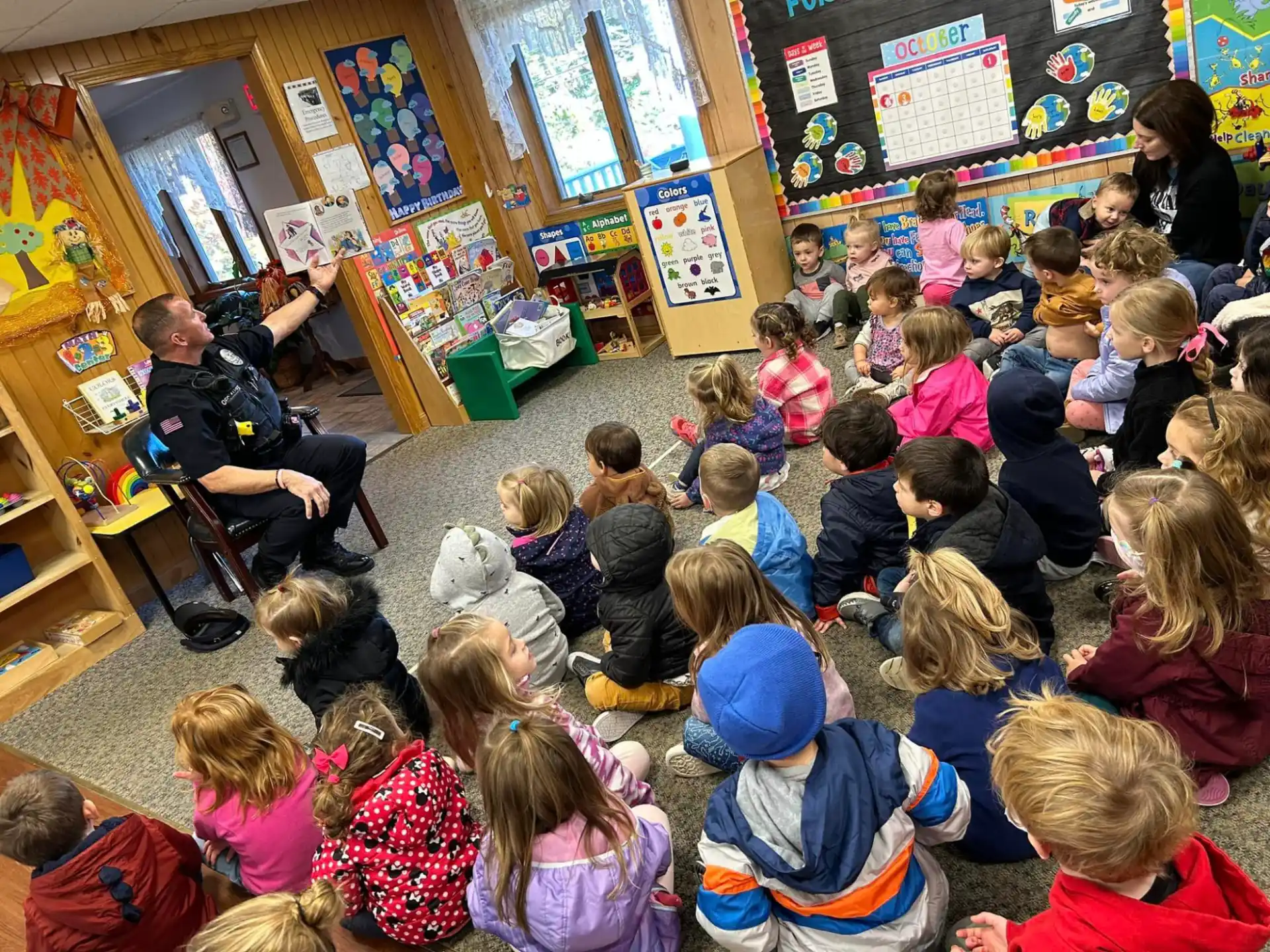 a group of children sitting in a classroom
