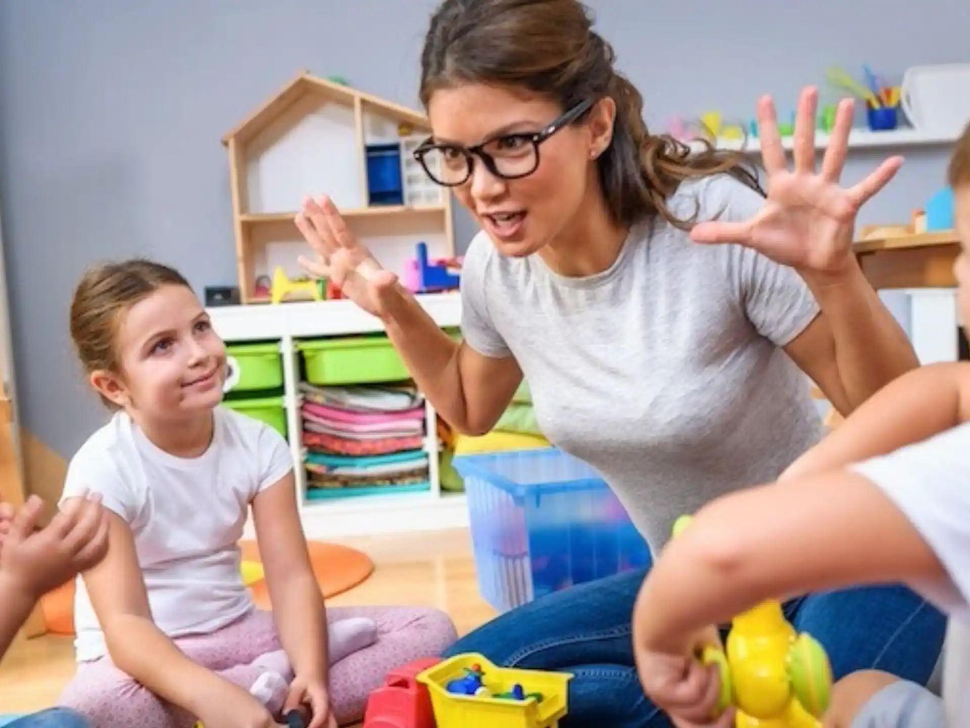 a person and children playing with toys
