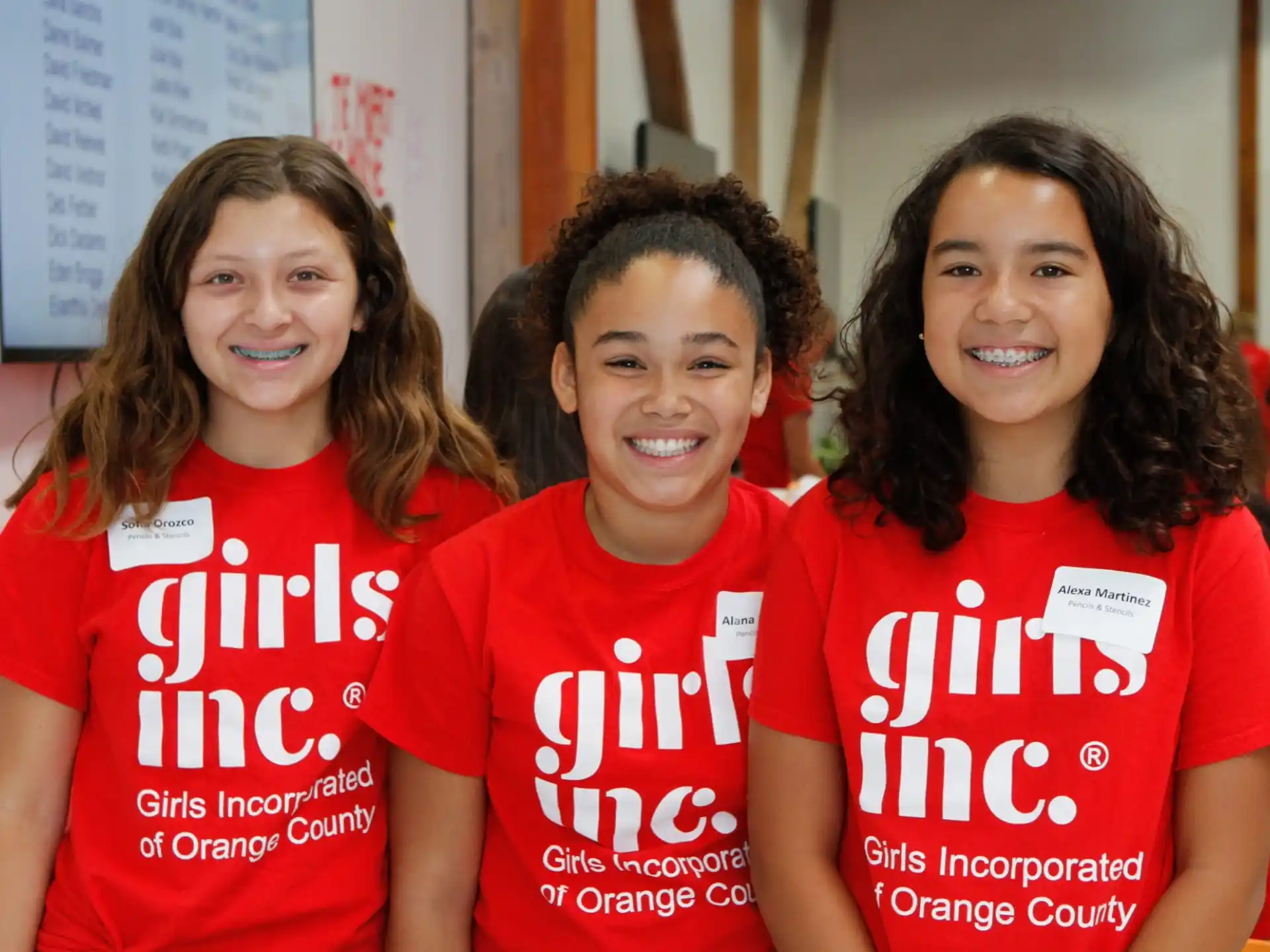 a group of women wearing red shirts