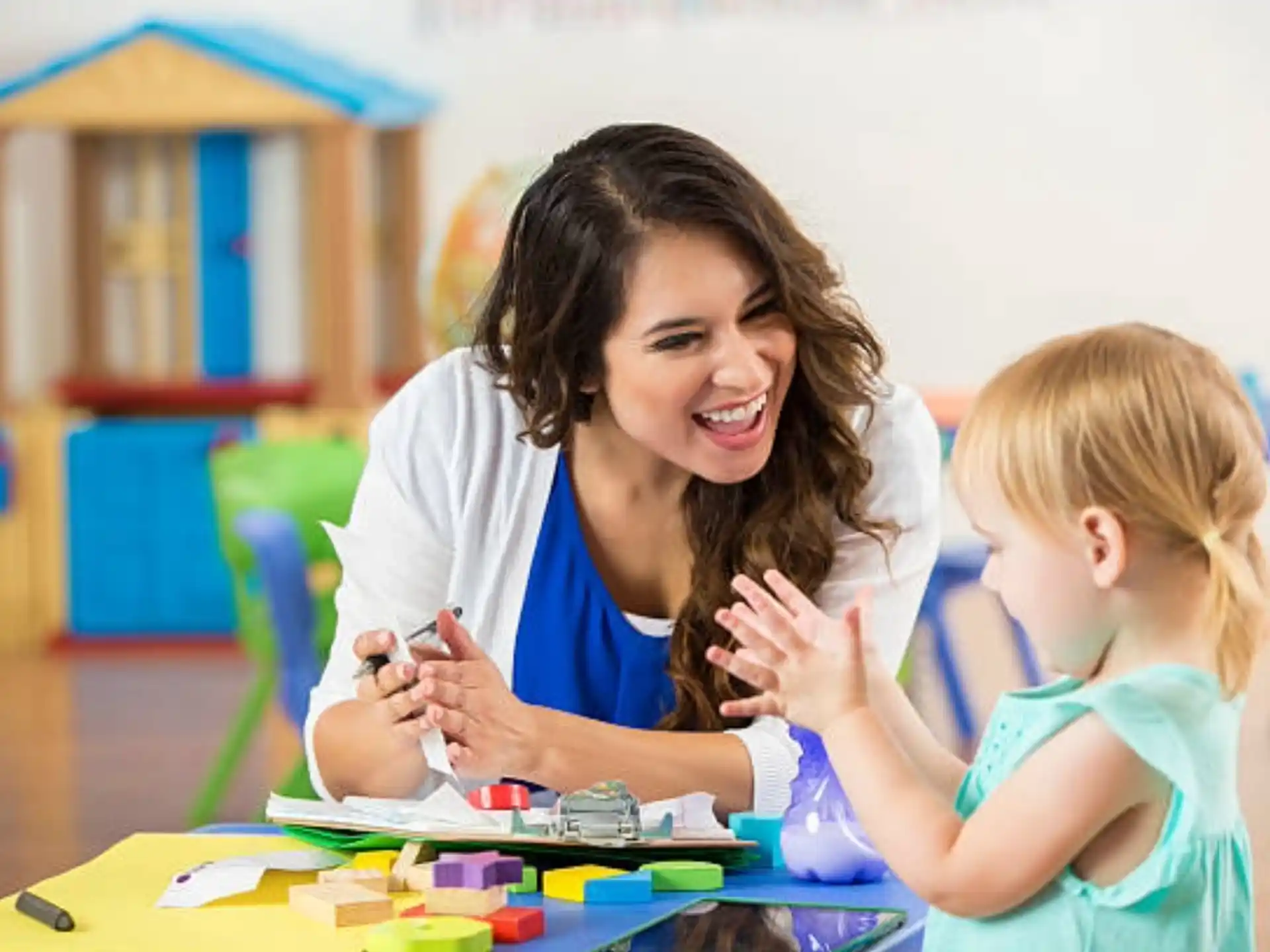 a person and a child playing with a toy