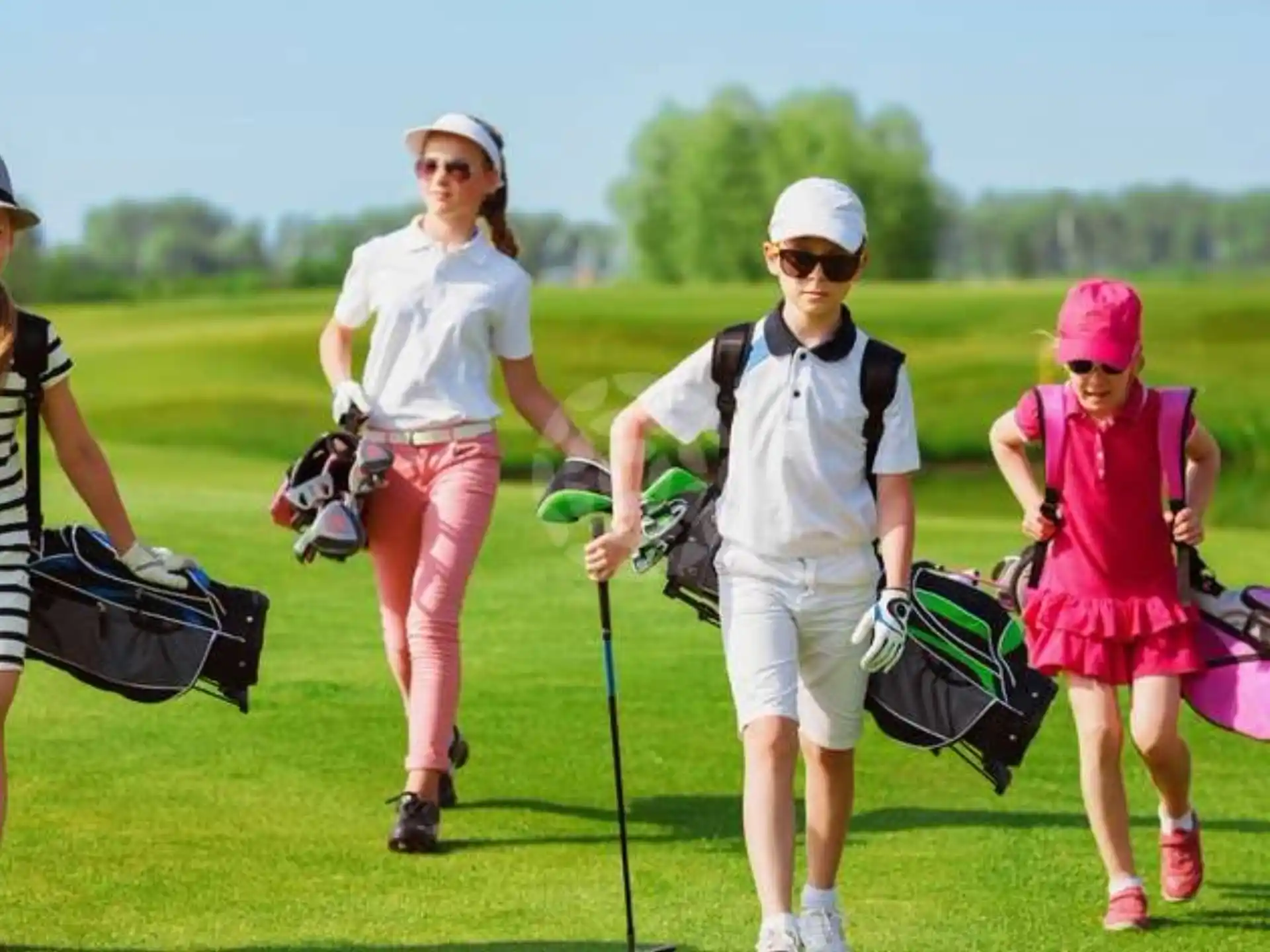 a group of people walking on a golf course