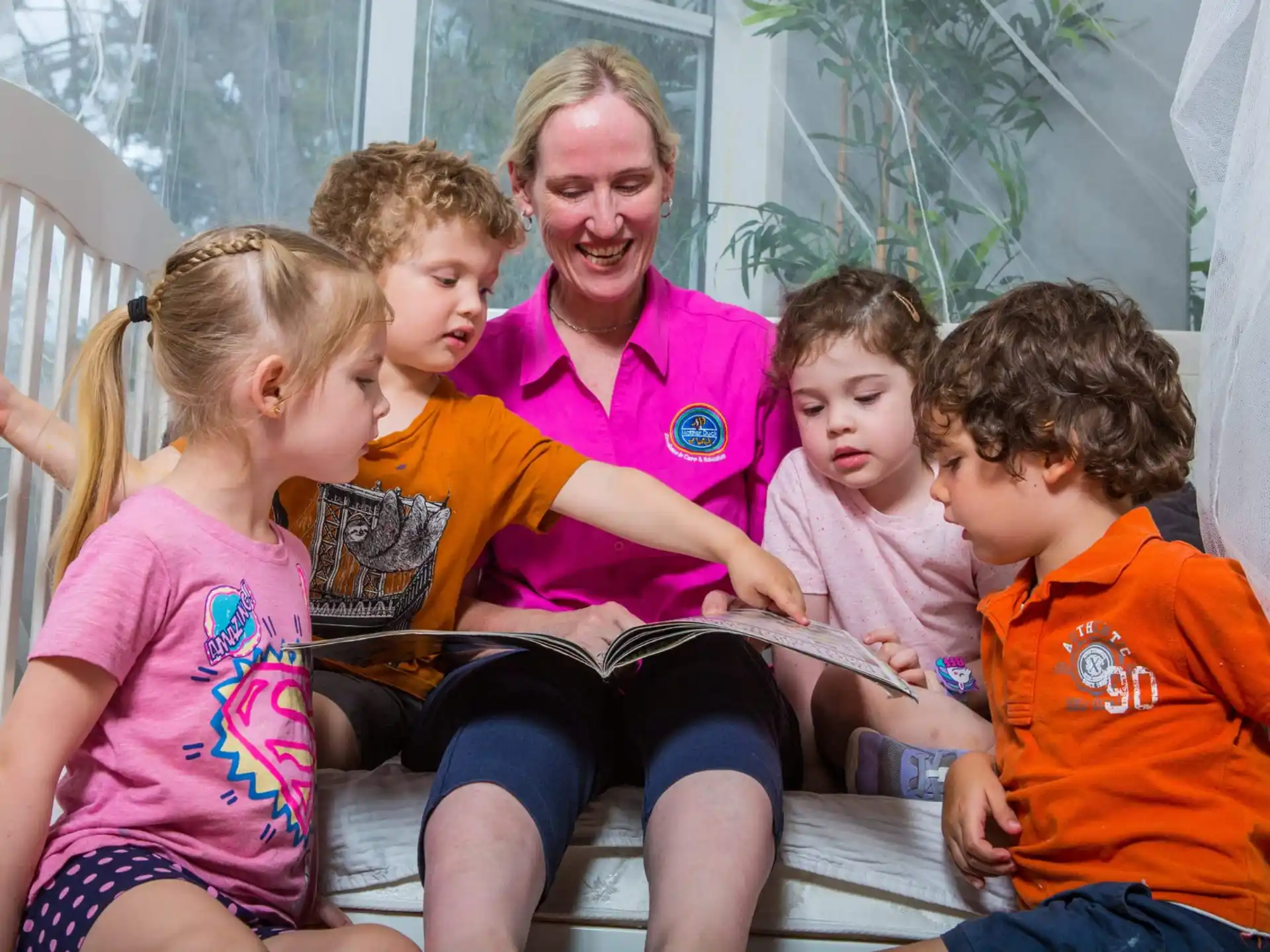 a person and several children sitting on a chair