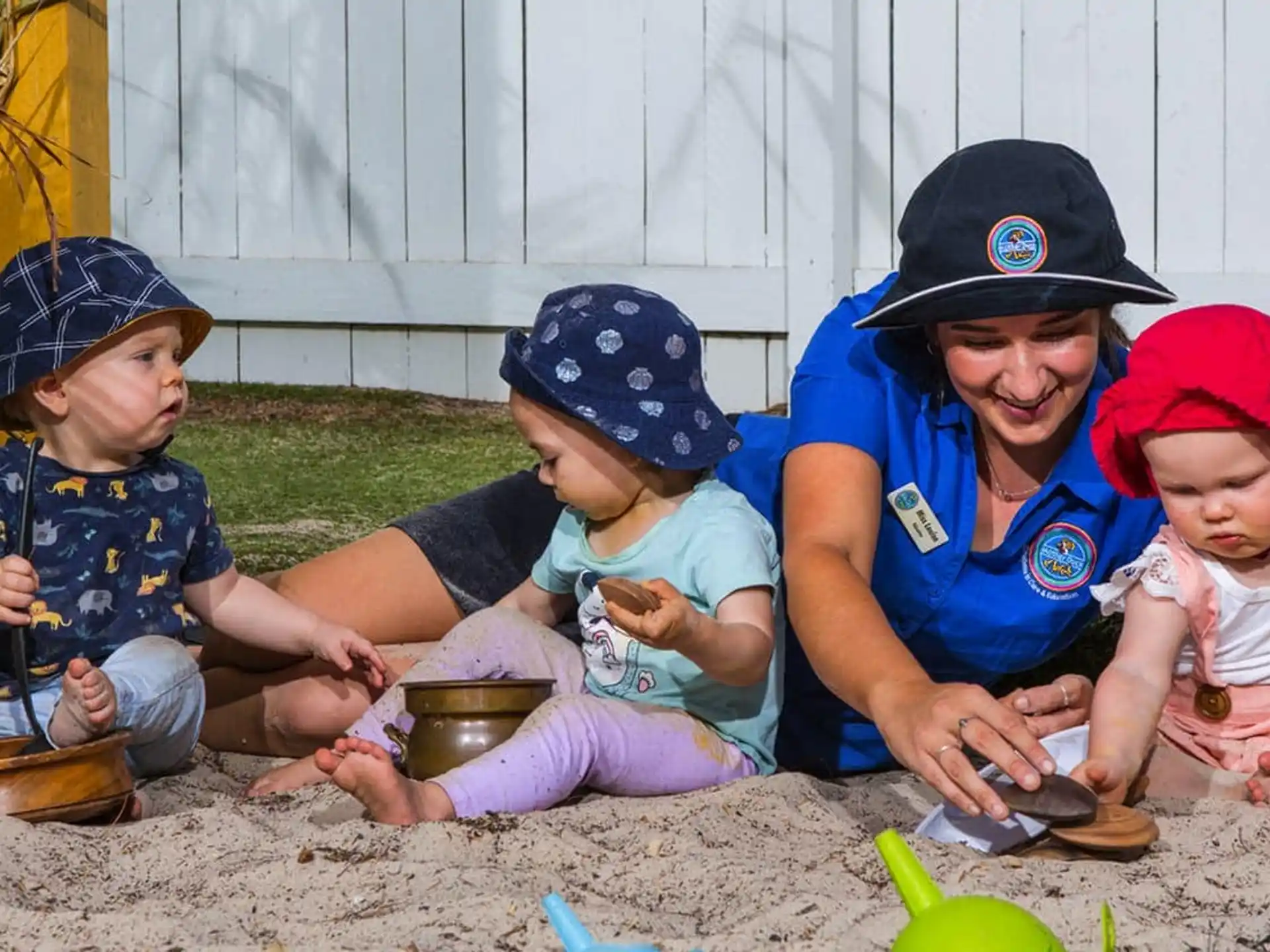 a person and two children sitting on the ground