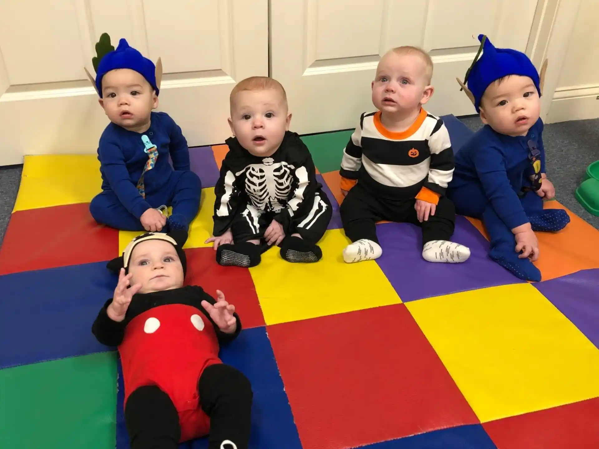 a group of children sitting on a rug