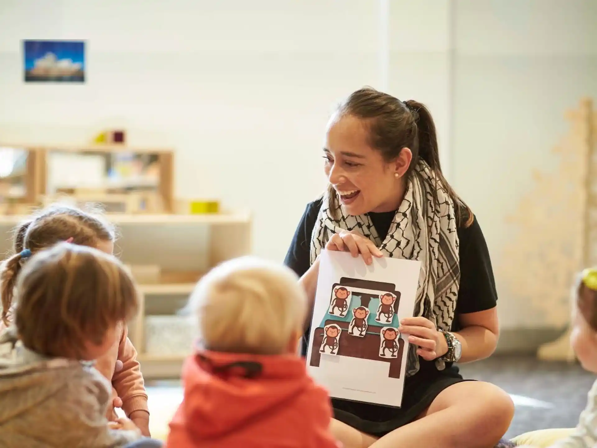 a person holding a book in front of a group of children