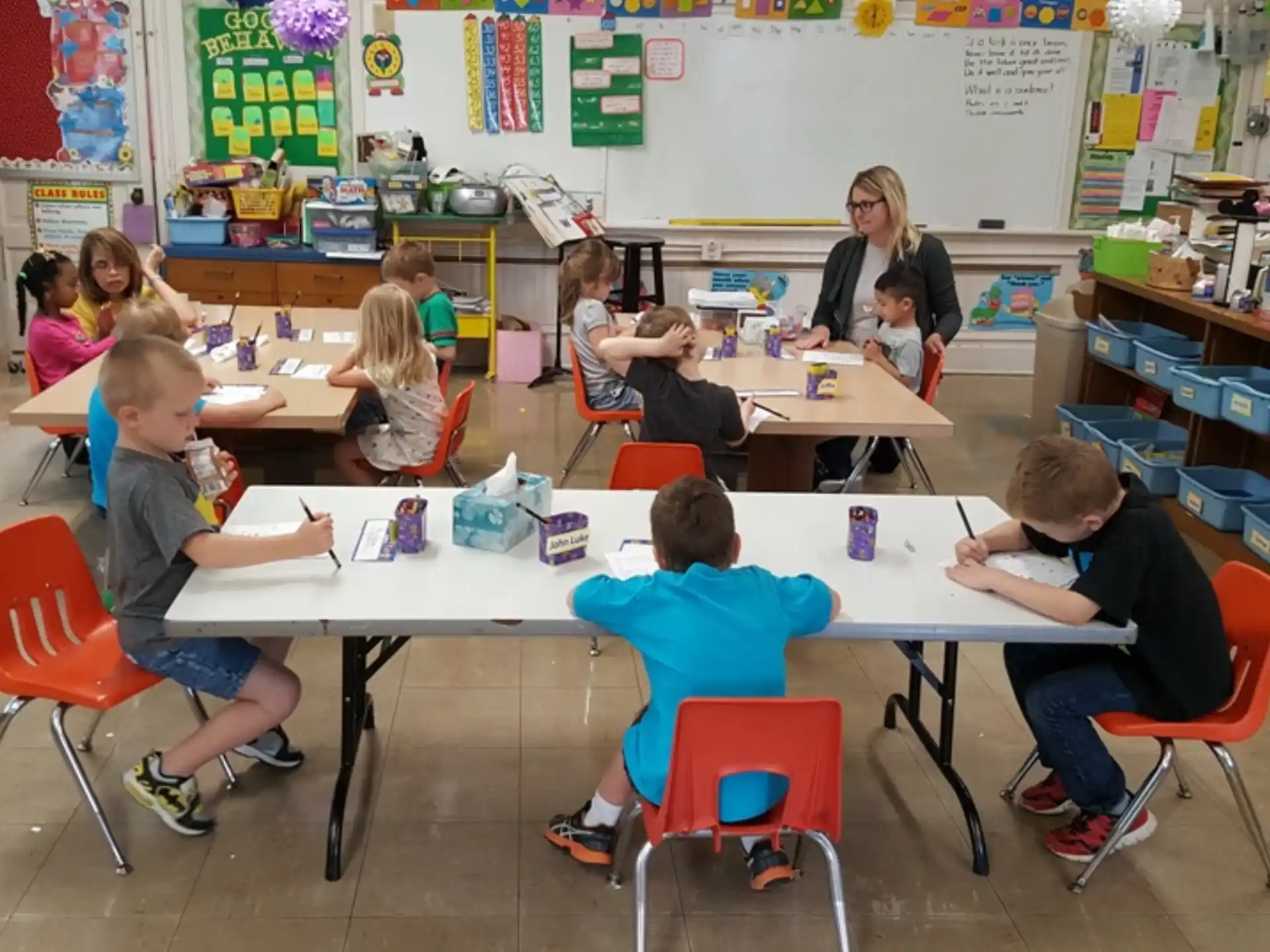 a group of children sitting around a table