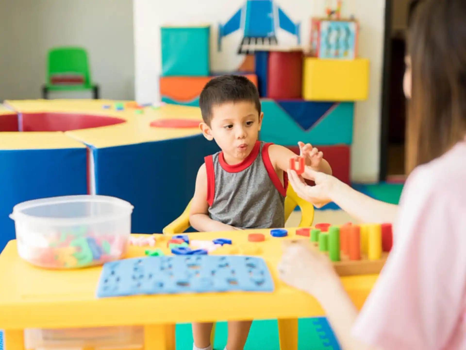 a person and a child playing with toys