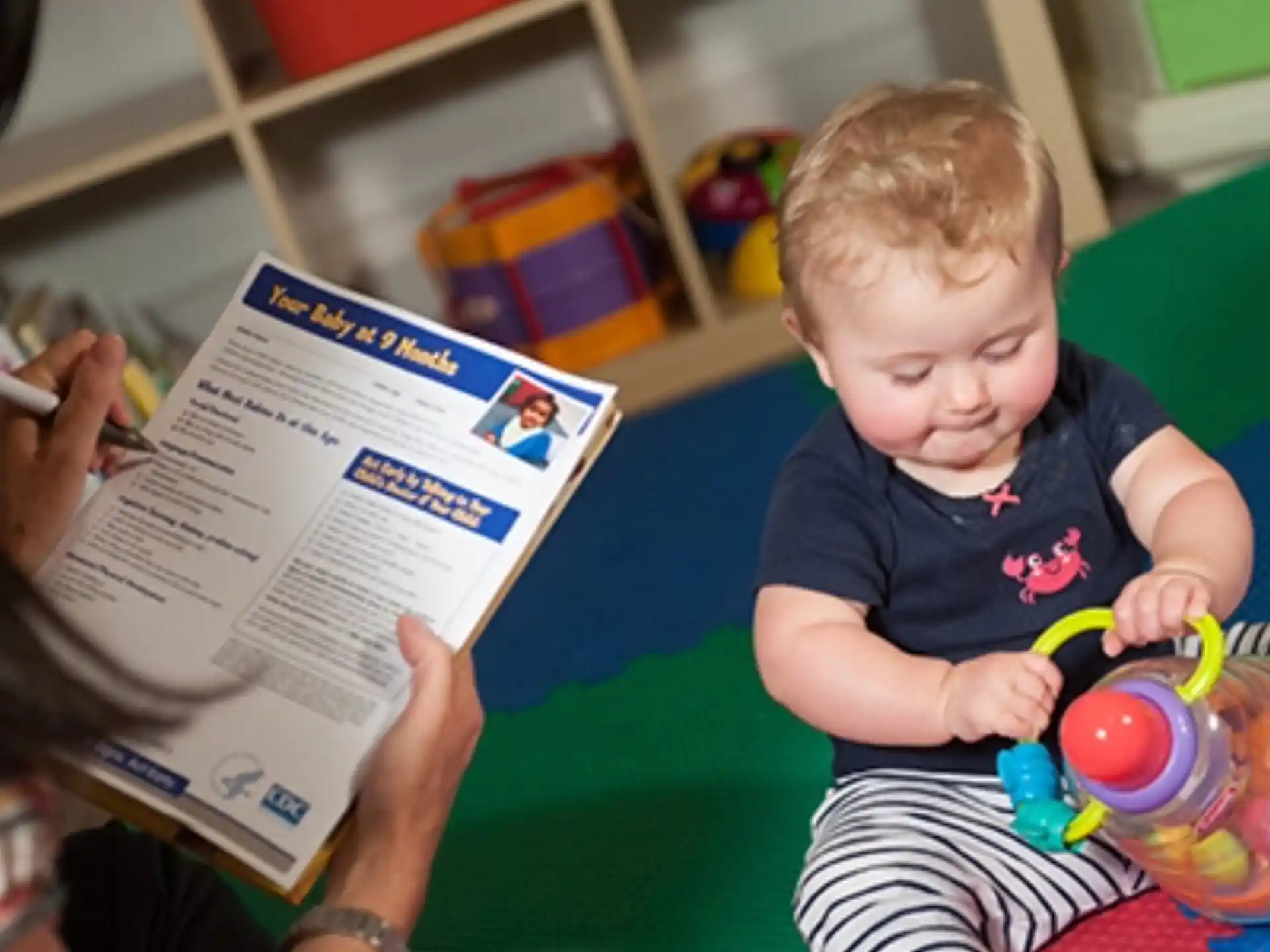 a person reading a book to a child