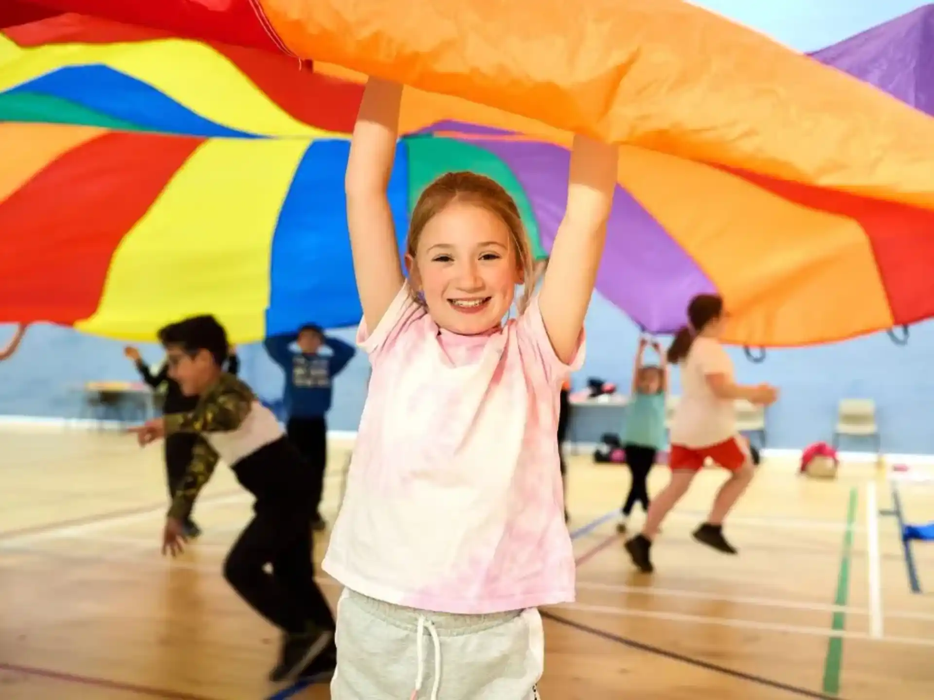 a person holding a rainbow umbrella