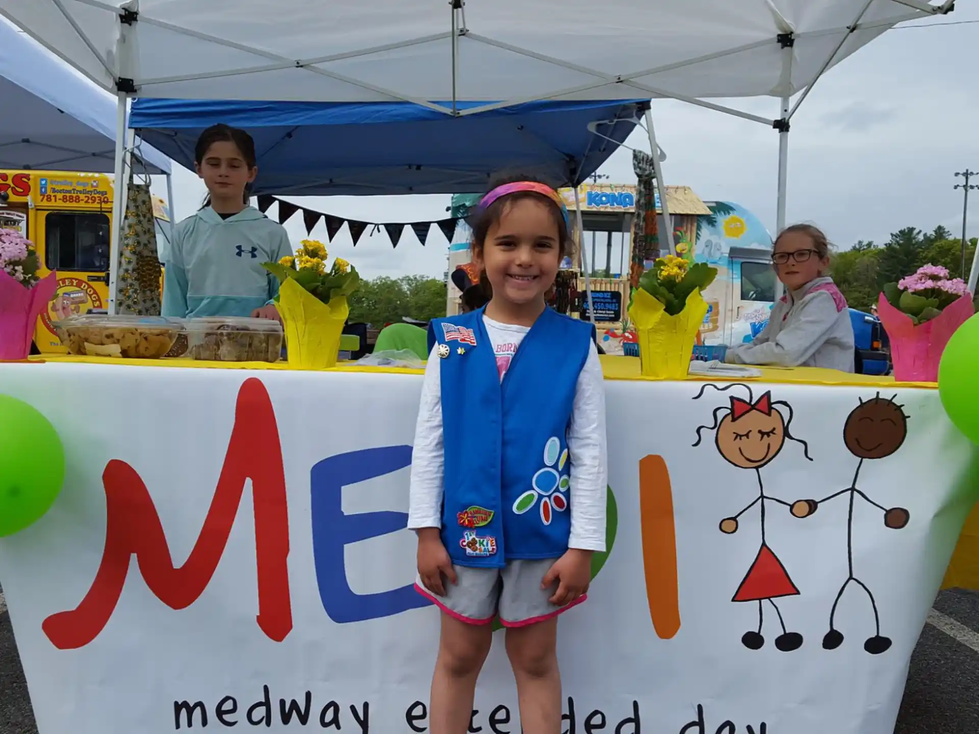 a girl standing next to a banner