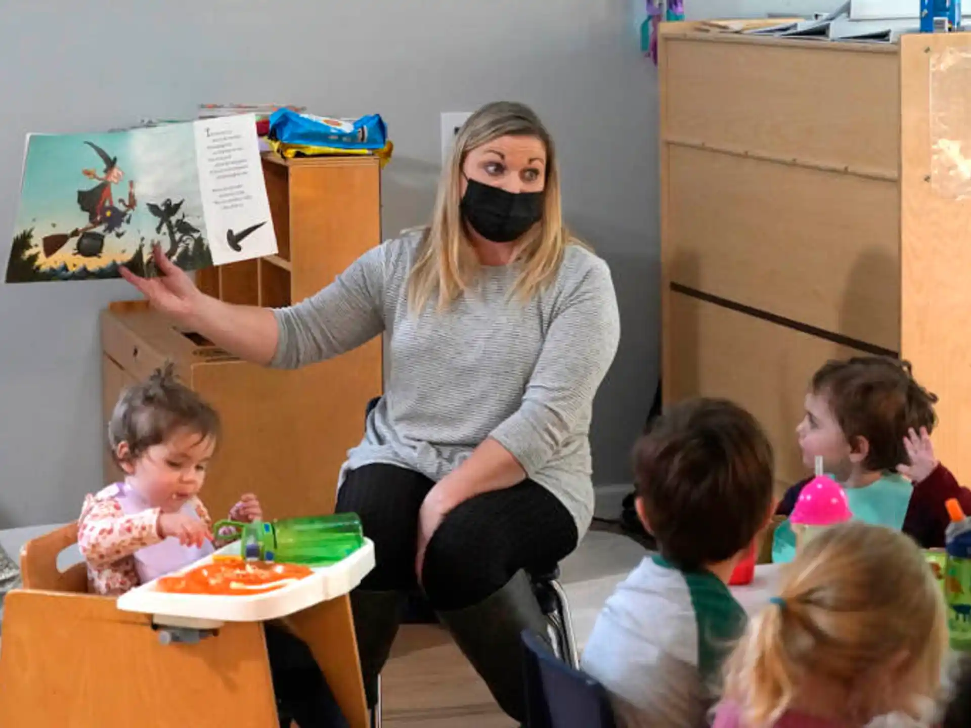 a person standing in front of a group of children